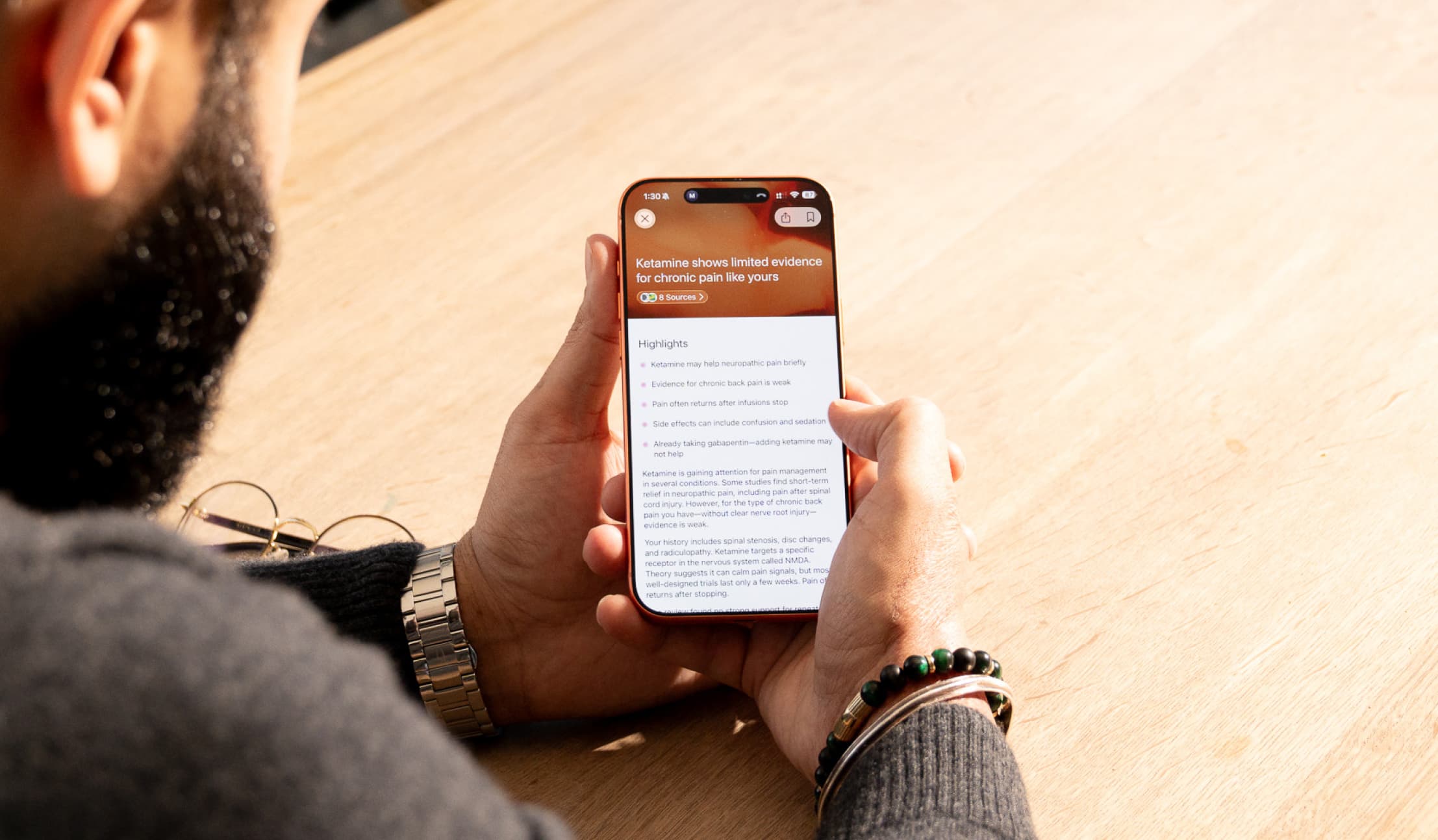 Person Reading Information on Ketamine for Chronic Pain Management on Smartphone
