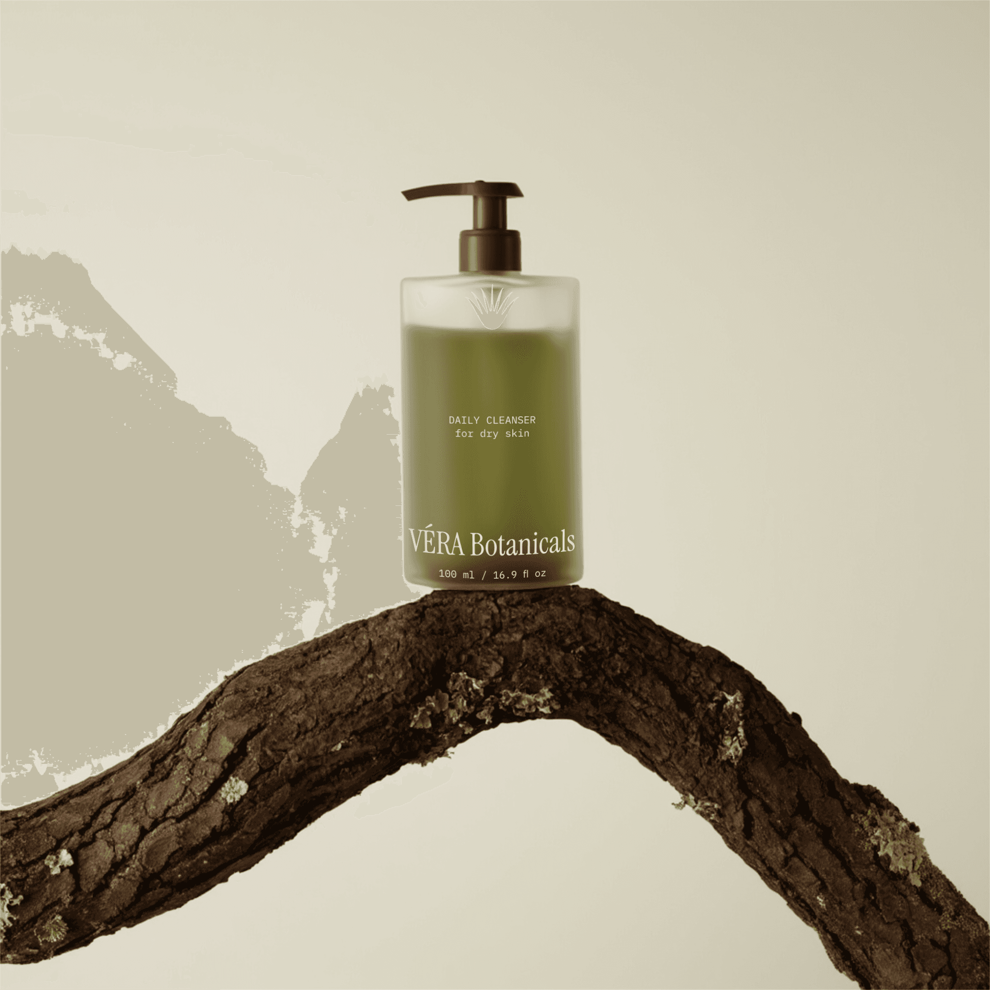 A skincare product bottle sitting on a branch. The bottle is clear with a frosted glass finish. The bottle contains an olive-green liquid.