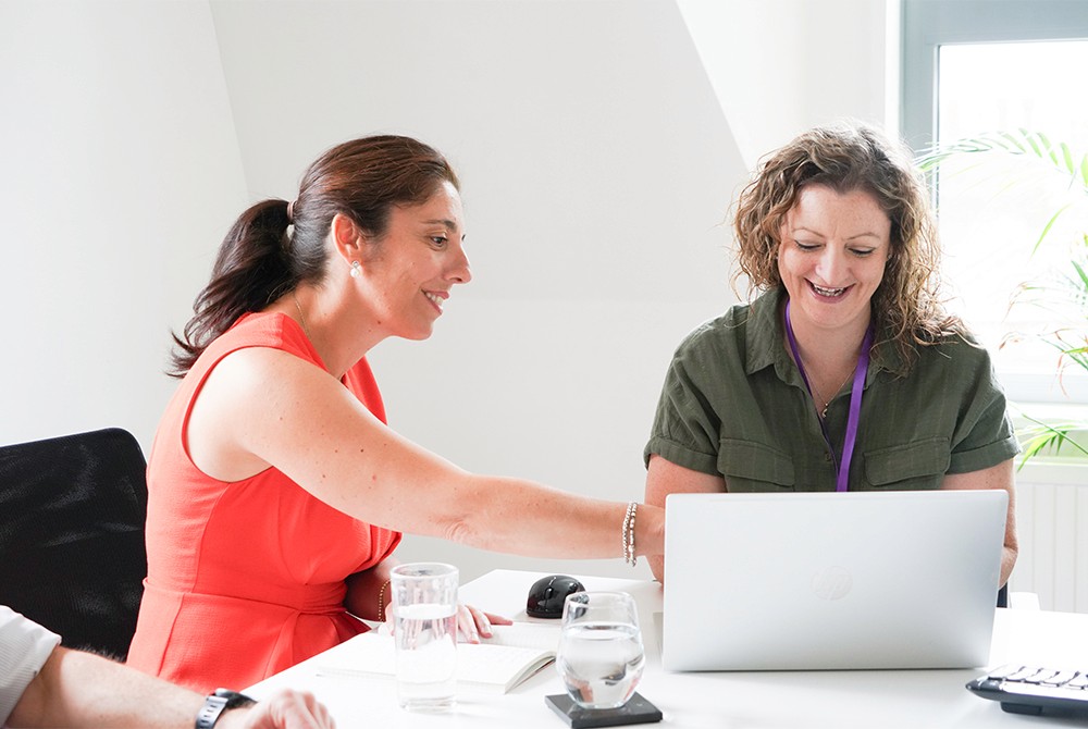 Hughes Price Walker team members reviewing pension administration information together on a laptop.