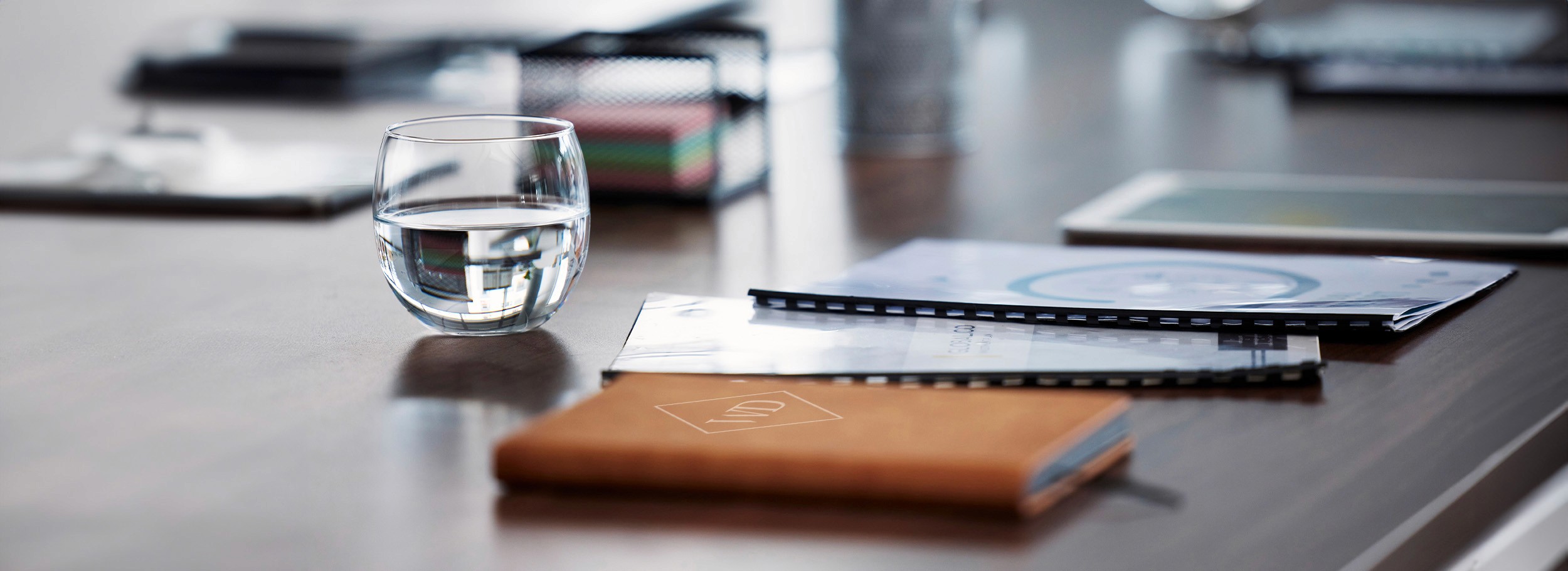 Notepads and booklets on a corporate boardroom meeting table