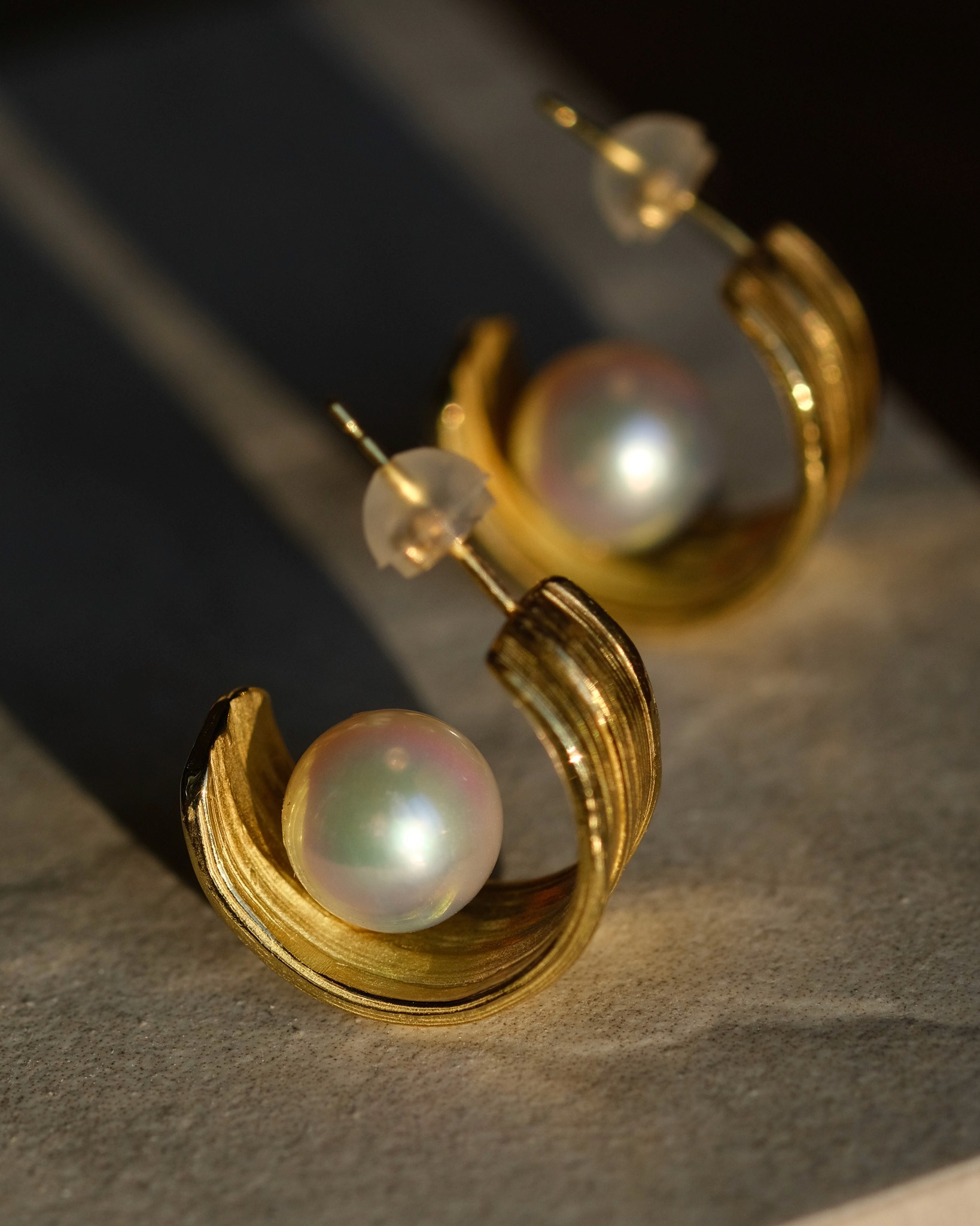 Large gold hoops with an Akoya pearl