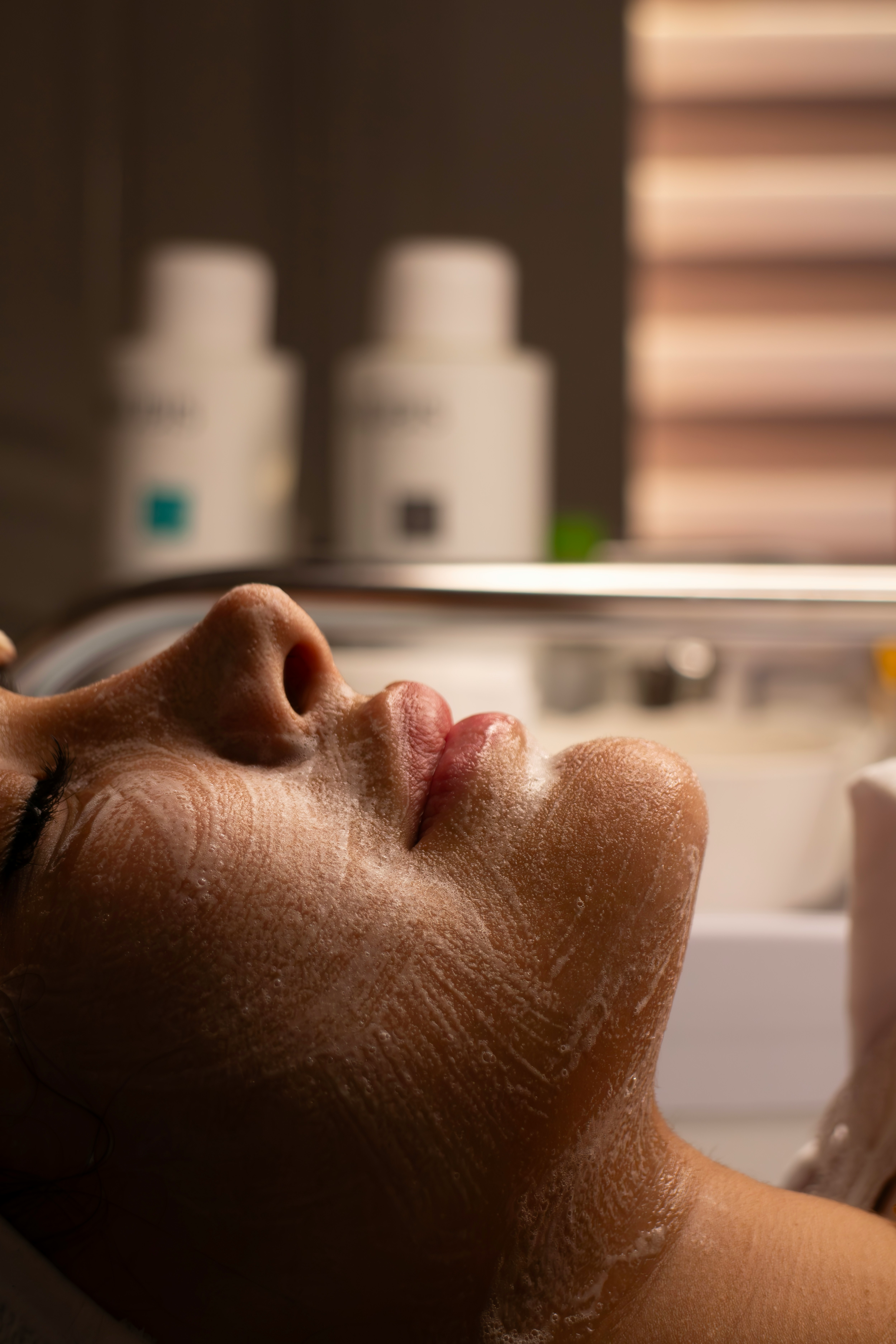 Close-up of a woman receiving a relaxing facial treatment representing custom facial services at Ash & Juniper Aesthetics Draper Utah