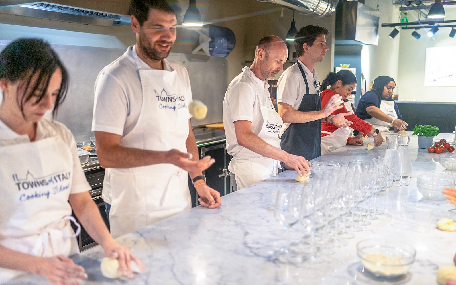 Participants making dough at a gelato and pizza class in Milan.