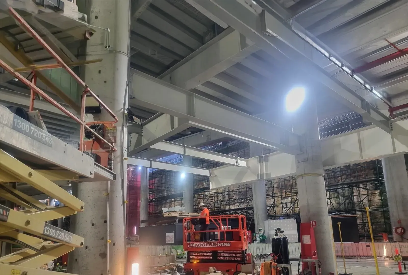 Workers on a scissor lift and scaffolding.
