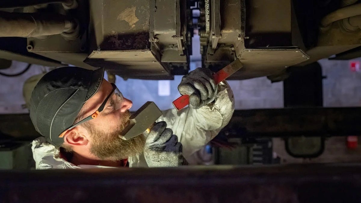 Mécanicien sous véhicule industriel en maintenance — photo reportage technique Lille | Anteale Yann Manac’h 2025
