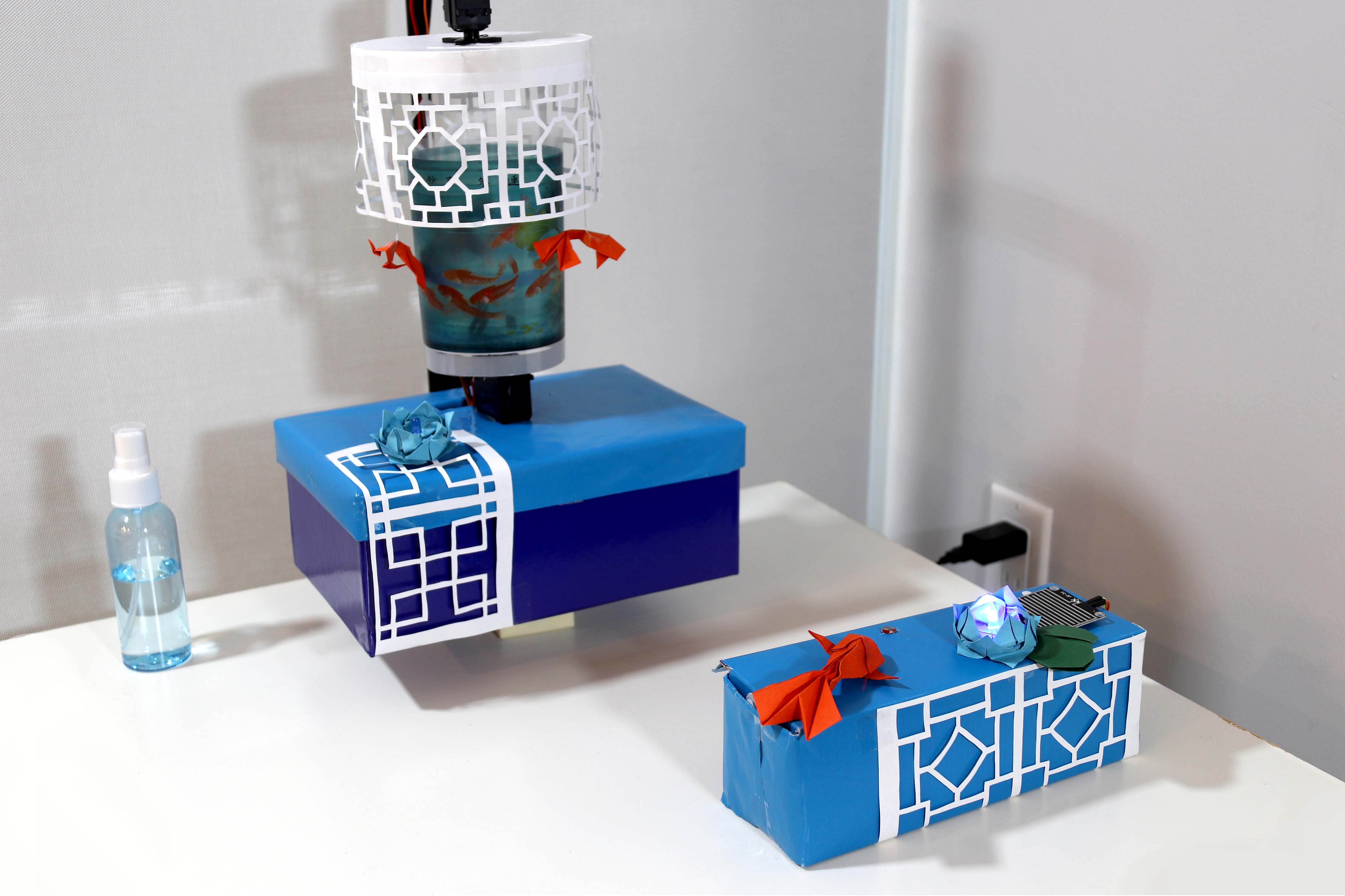 Bluetooth-controlled installation combining a paper lantern, illuminated lattice boxes, and moving koi elements.