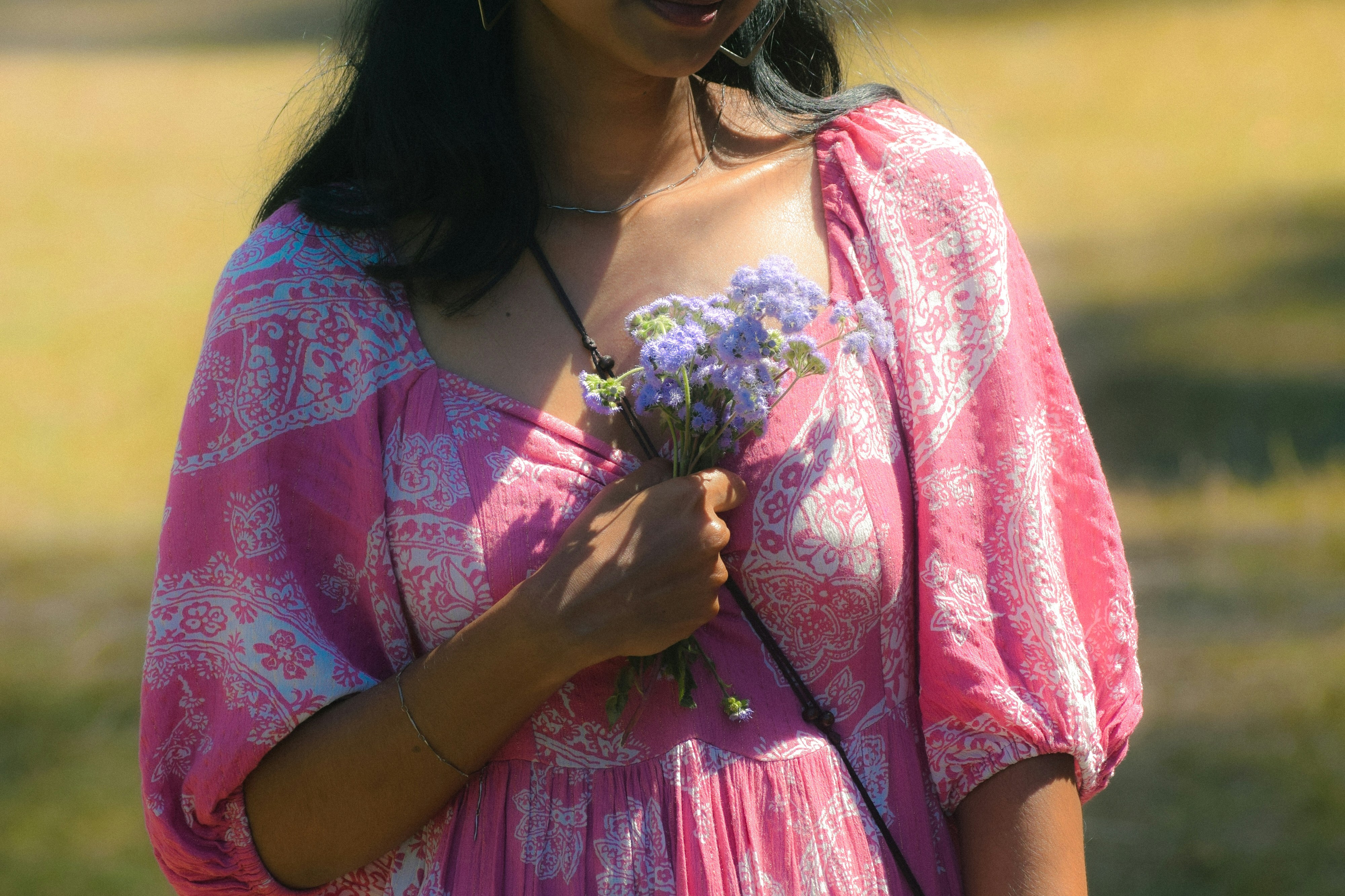 A woman holds a bouquet of flowers.