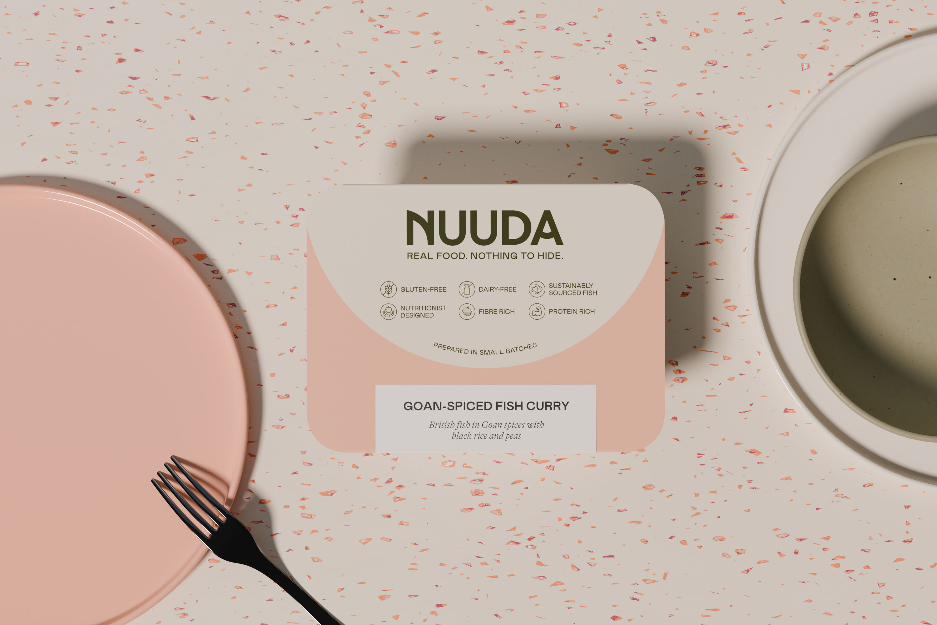 Nuuda meal sleeve for Goan-Spiced Fish Curry with salmon pink colour coding and dietary icons on a terrazzo surface