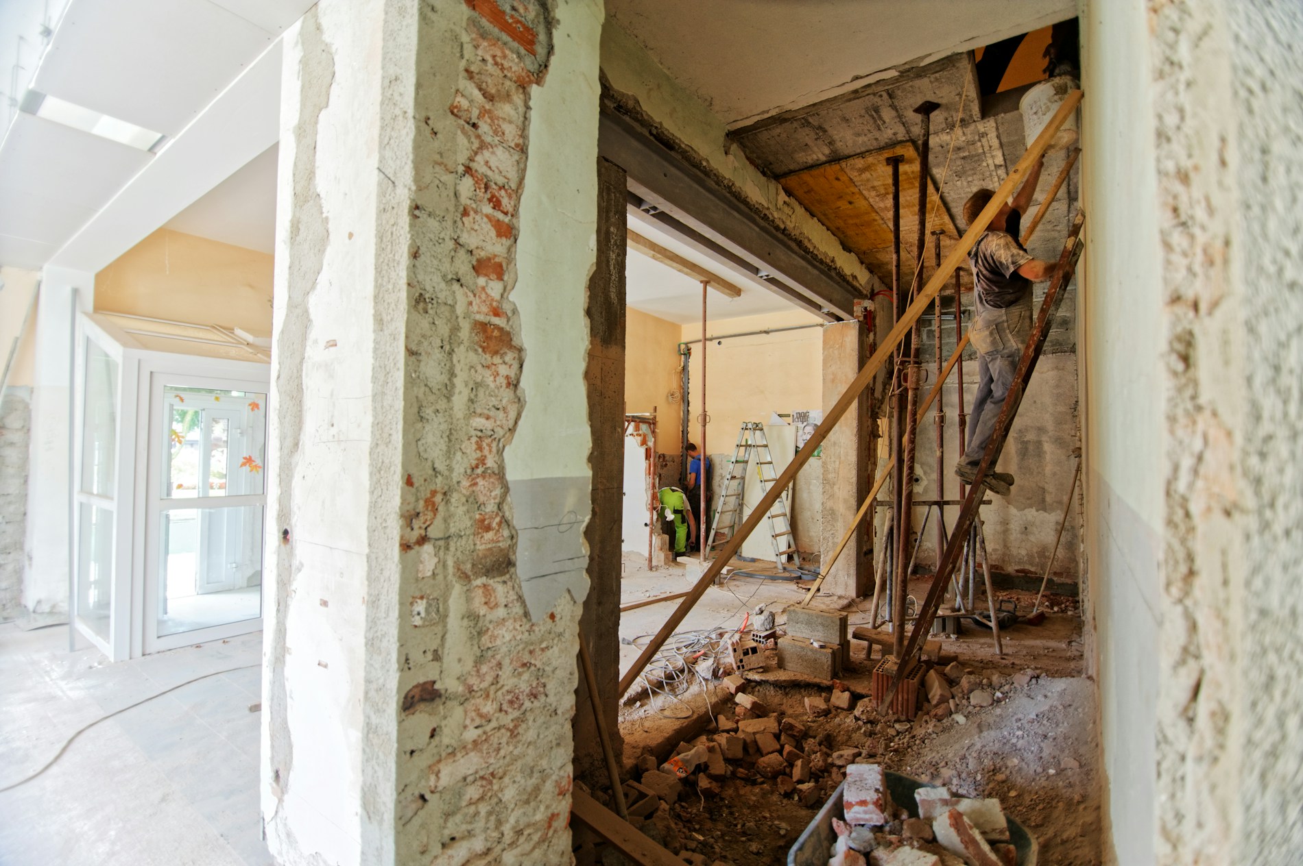 Construction worker on a ladder inside a renovation project