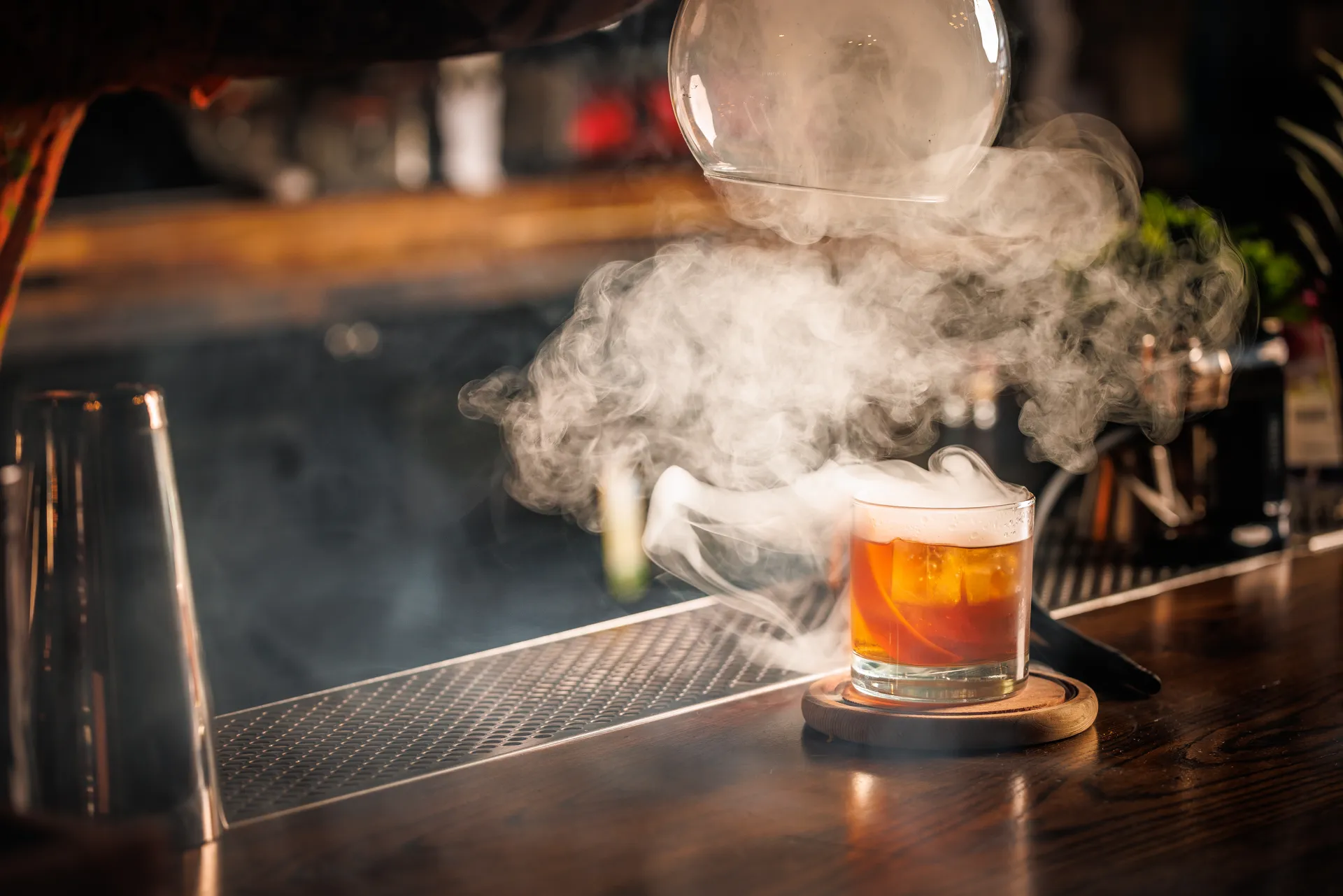 Old fahsioned being smoked under a glass container