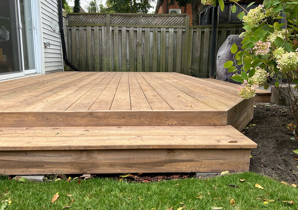 New deck installation with step down onto grass