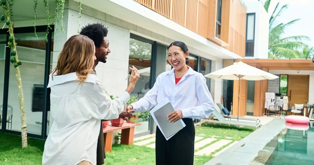 A young couple with a Real Estate Agent. 