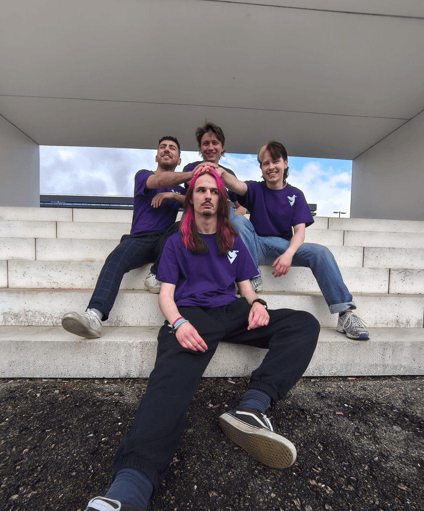 Yoshi, Jasper and Josef playfully placing their hands on Lars' head on the stone steps outside