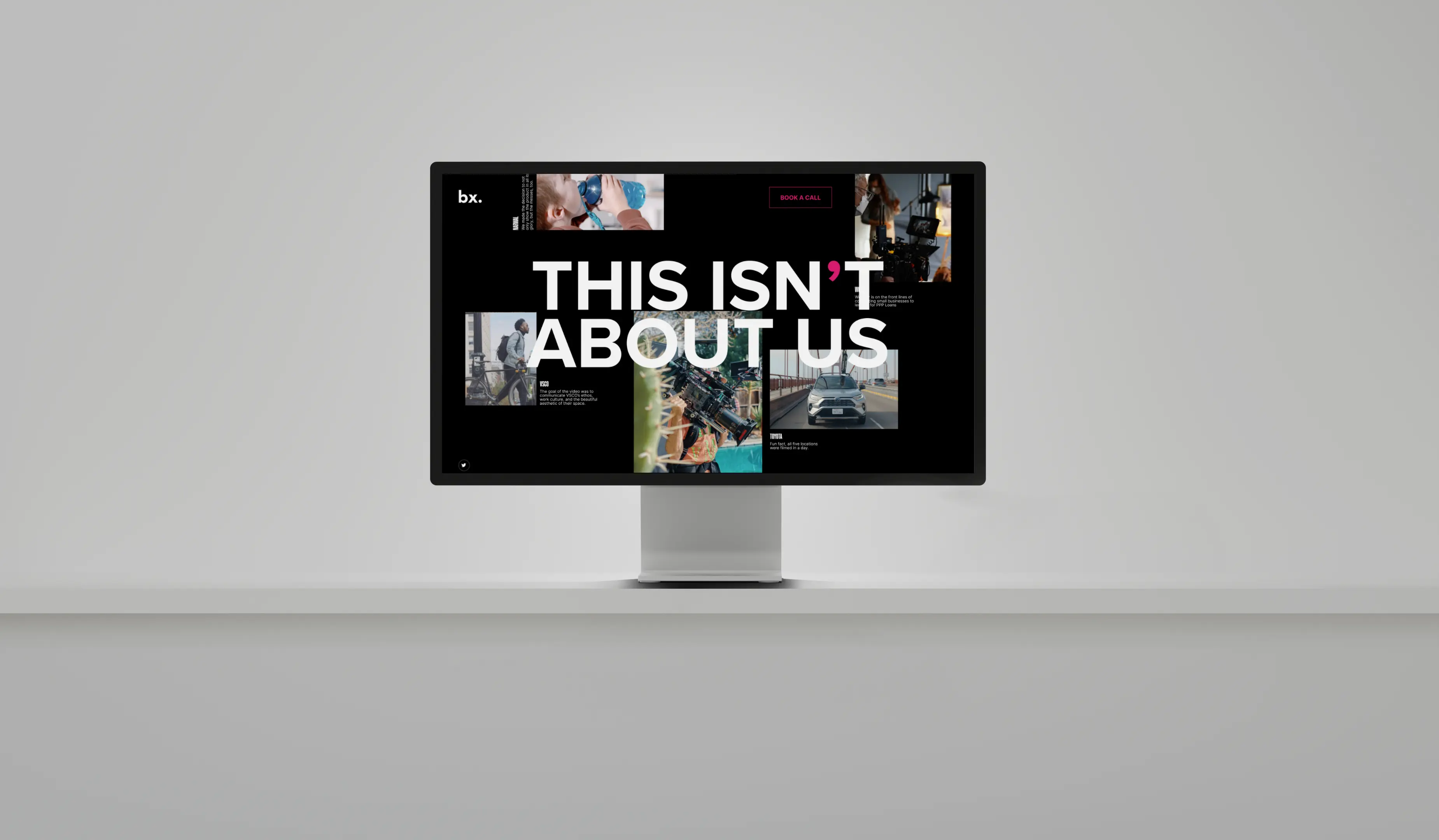 A digital display on a pedestal showing text and images in a modern, minimalist exhibition space.