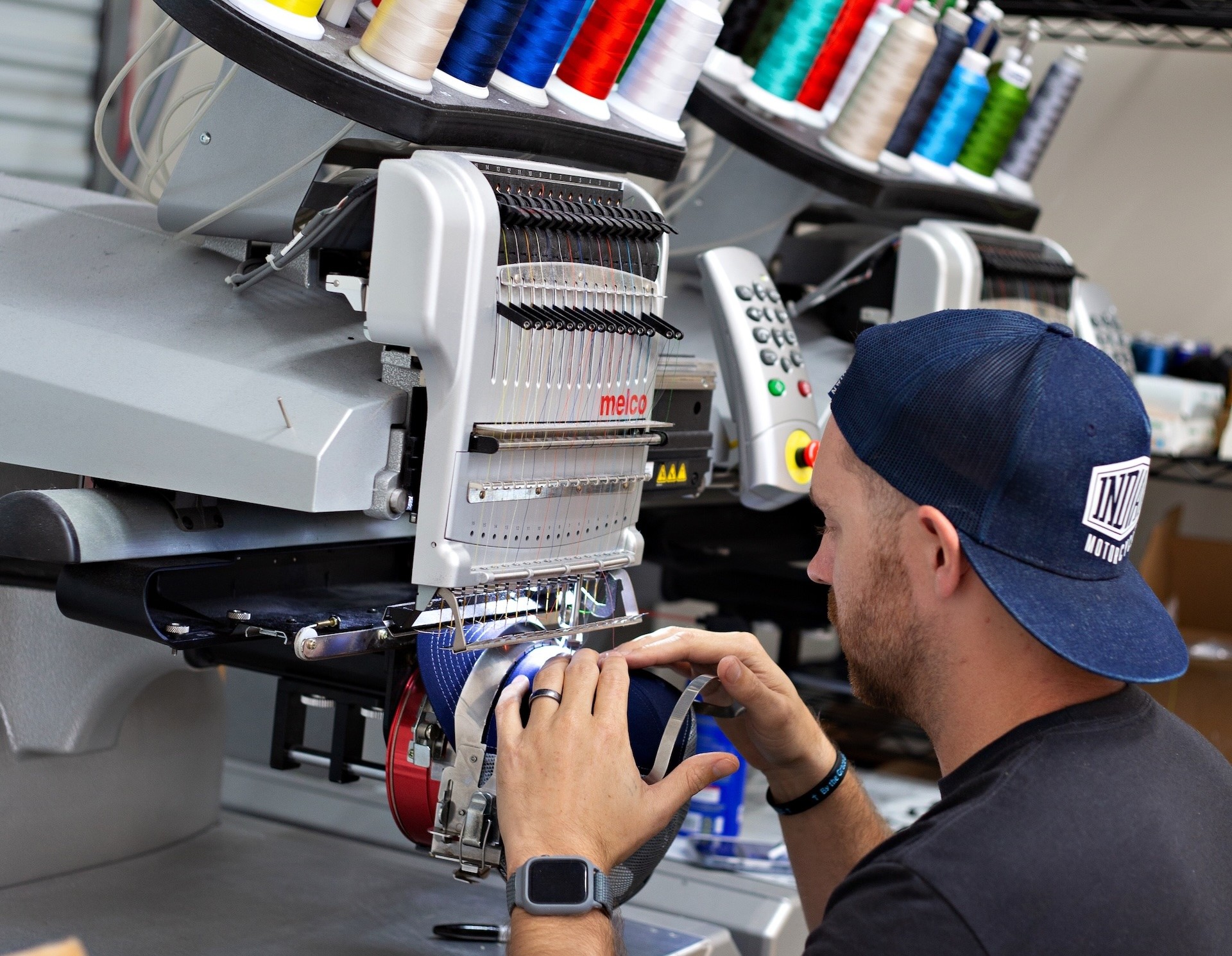 Man embroidering hat