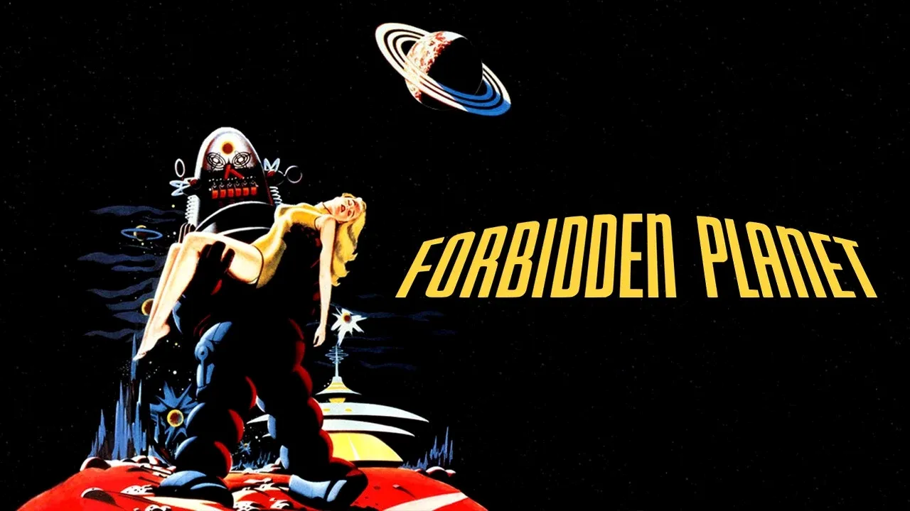 A retro sci-fi movie poster featuring a large robot holding a woman against a starry space background, with the planets Saturn and others visible, alongside the bold title "FORBIDDEN PLANET" in yellow letters.