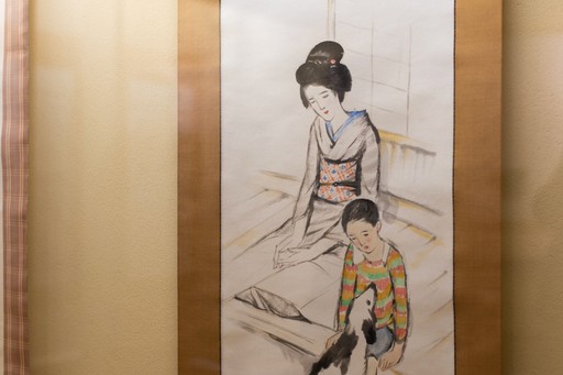 Close up of Yumeji's art work of a Japanese womean wearing a pink and red kimono