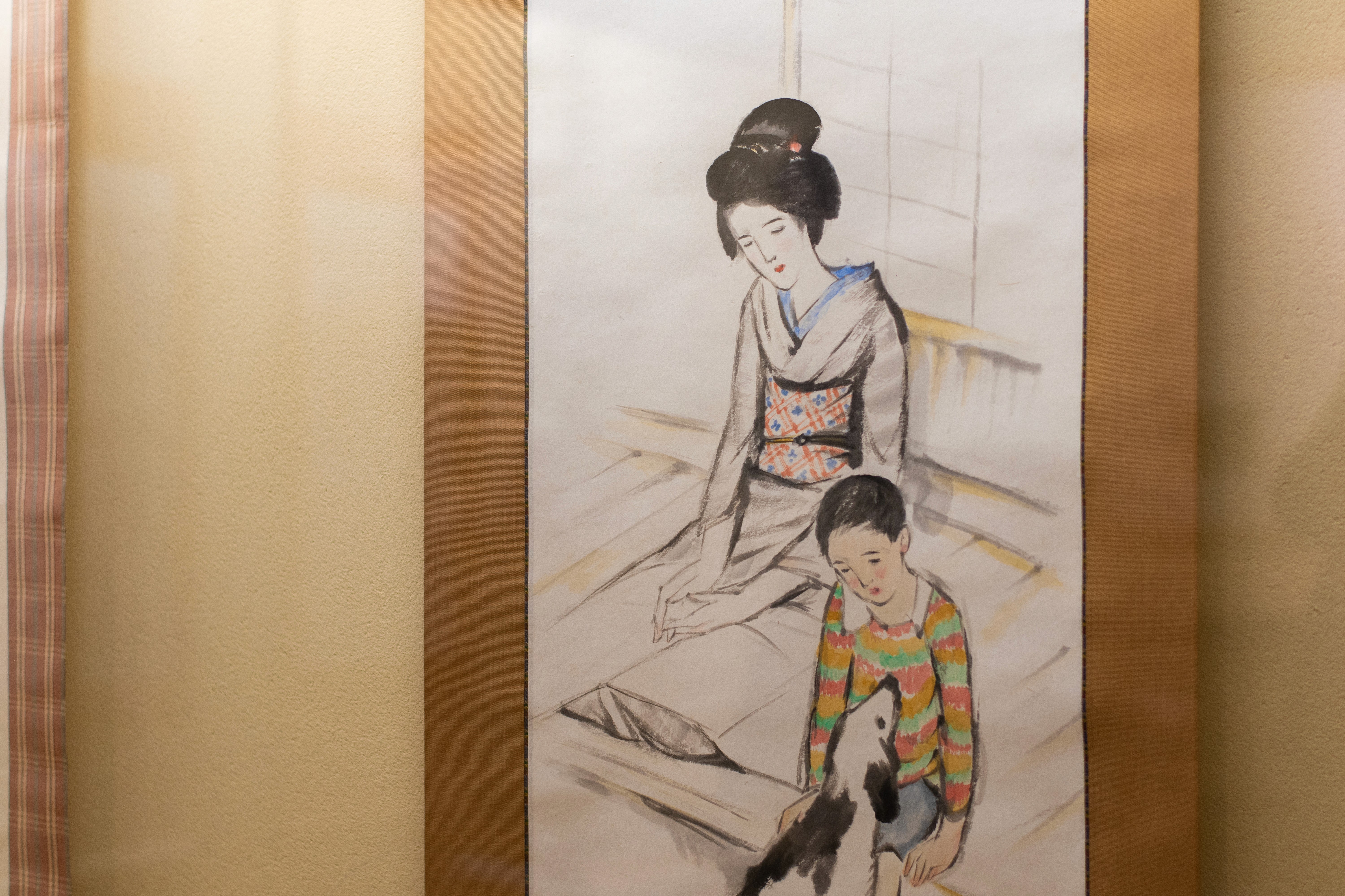 Close up of Yumeji's art work of a Japanese womean wearing a pink and red kimono