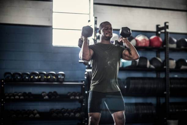 a man exercising wth dumbells