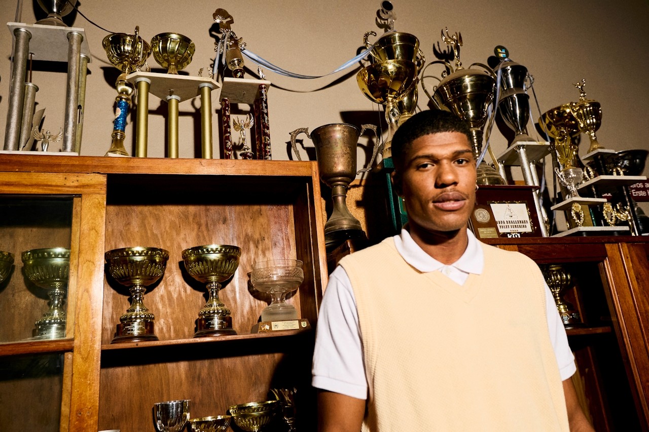 A potrait of a guy standing in trophy room