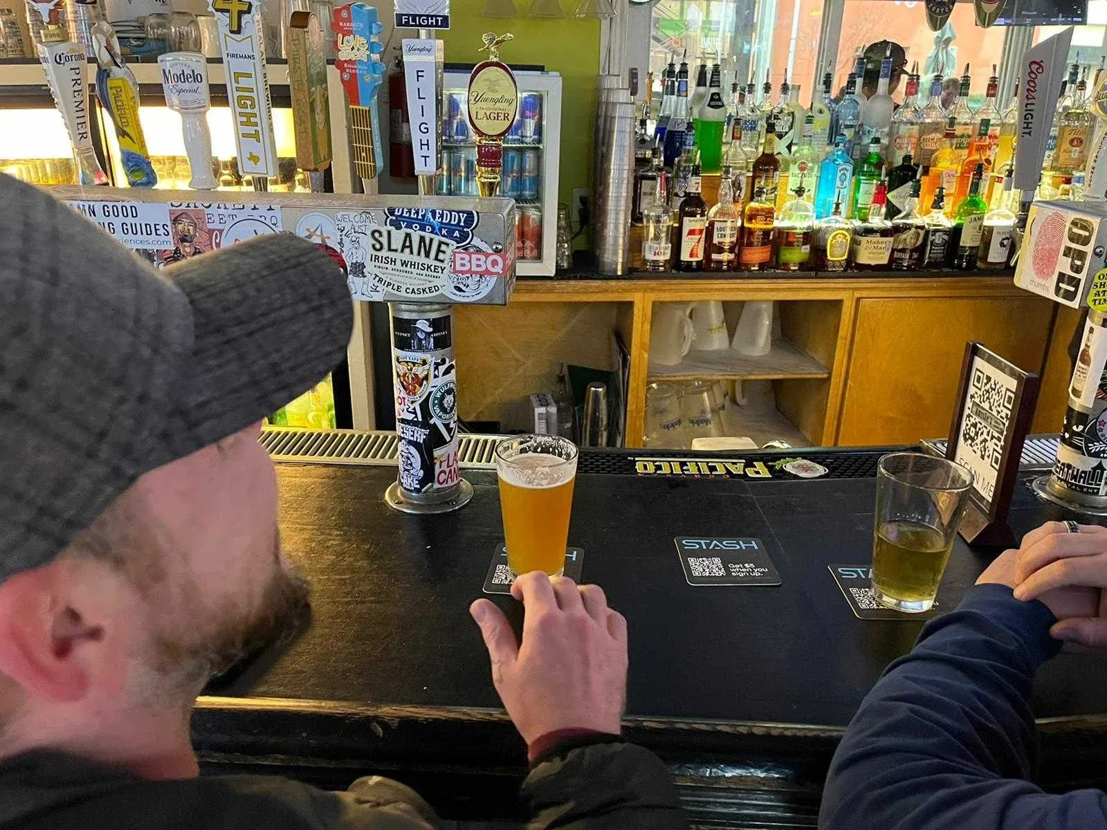 Drinks resting on Stash coasters at a bar