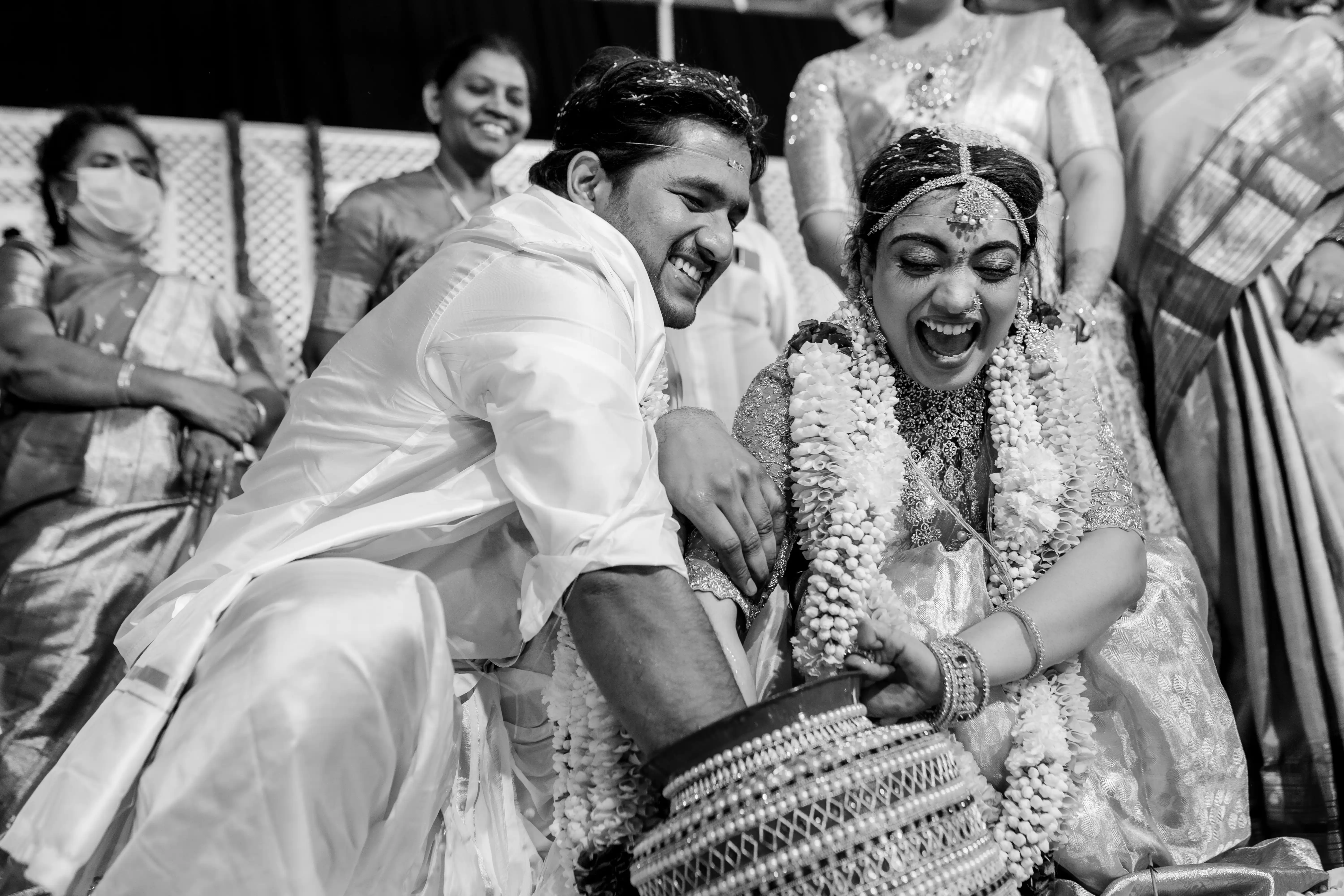 Black and white fine art wedding photograph of a joyful bride and groom on their special day. Captured by Out of The Blues in Hyderabad.