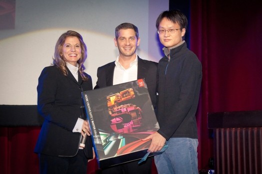 portrait of two men and a woman, holding a large product box