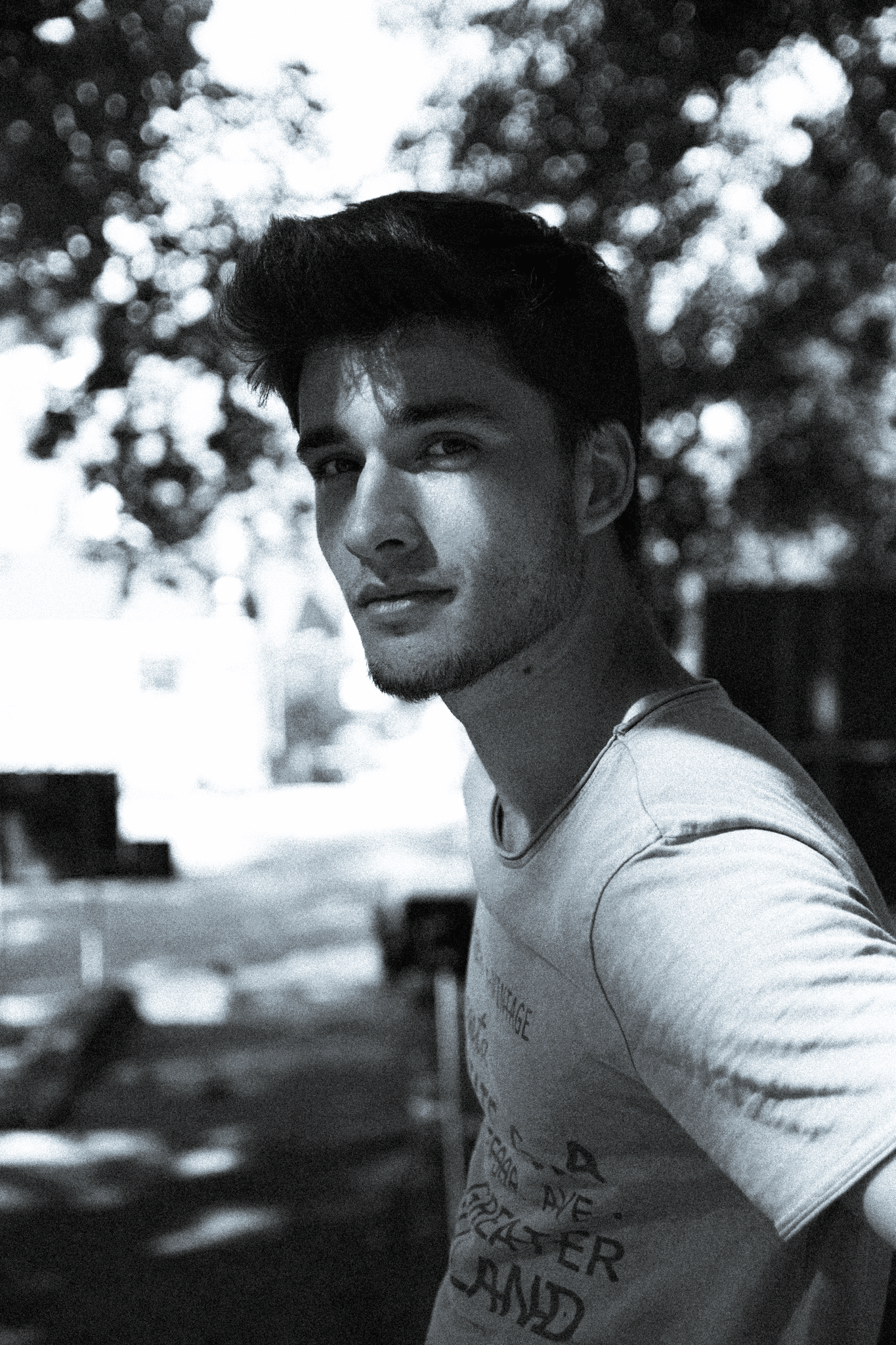 Portrait of a person in dark clothing speaking on a phone