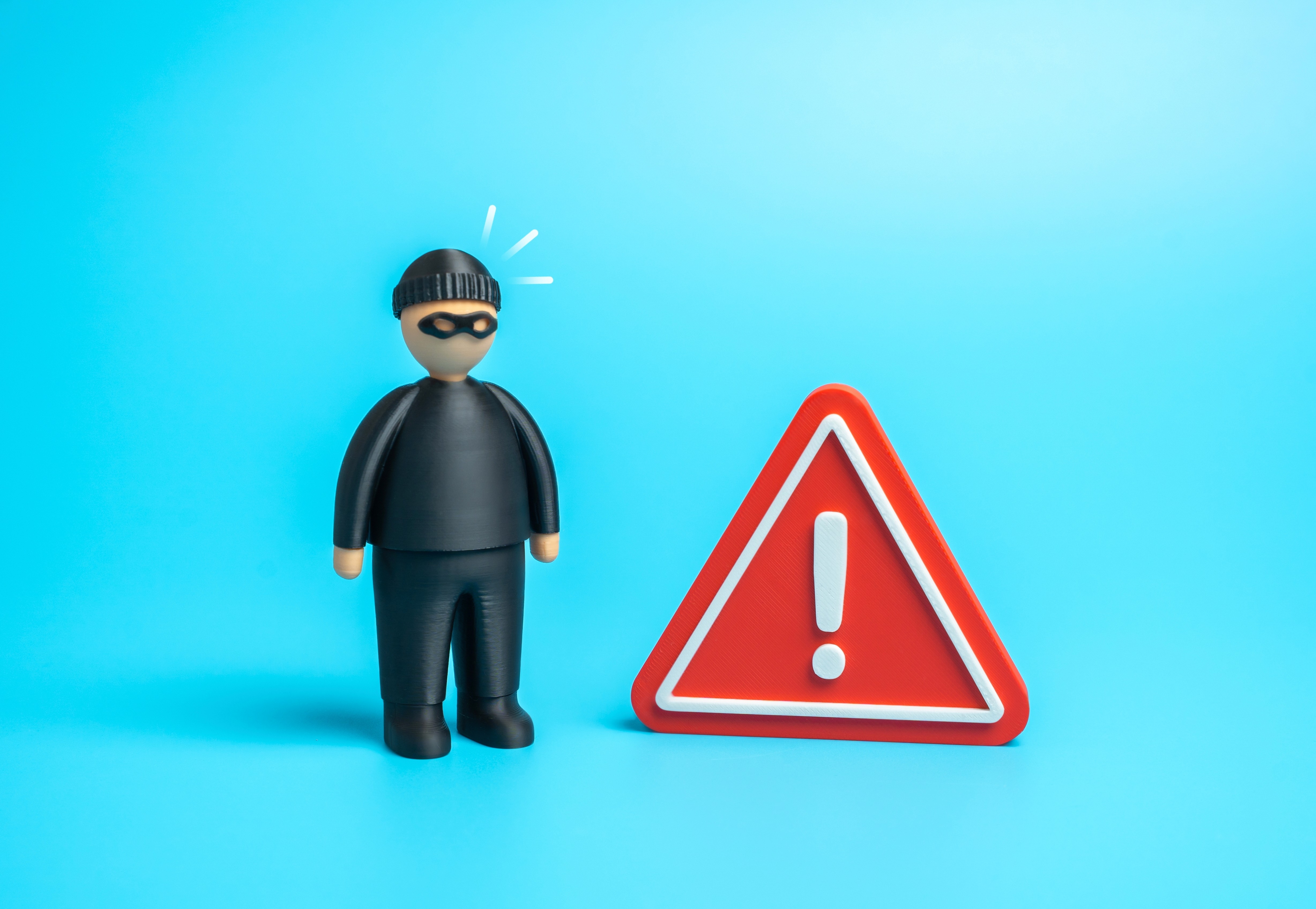 Installer fitting a wireless motion sensor alarm in a commercial property hallway.