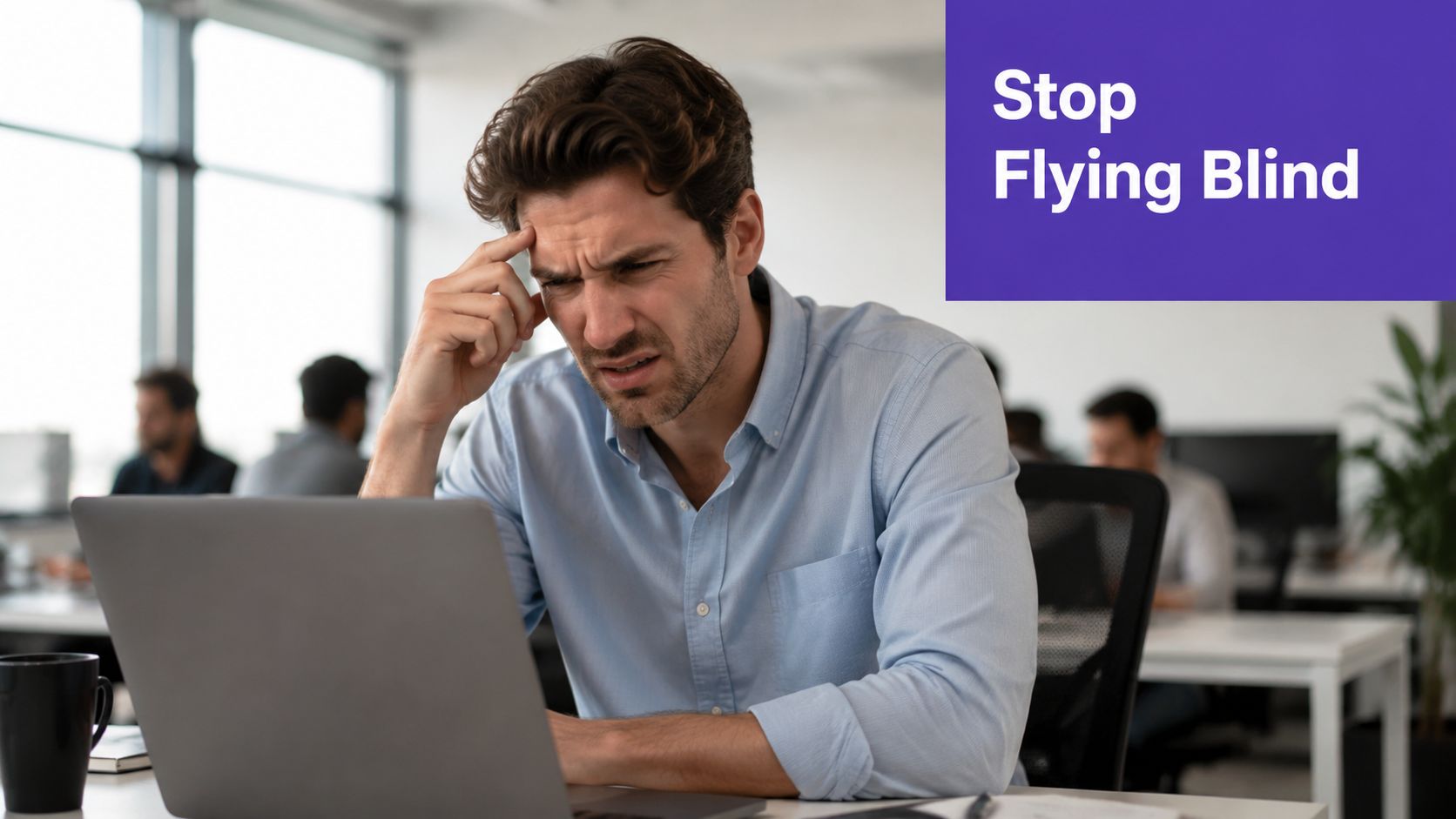 A concerned office worker looking at a laptop screen in a modern workplace environment