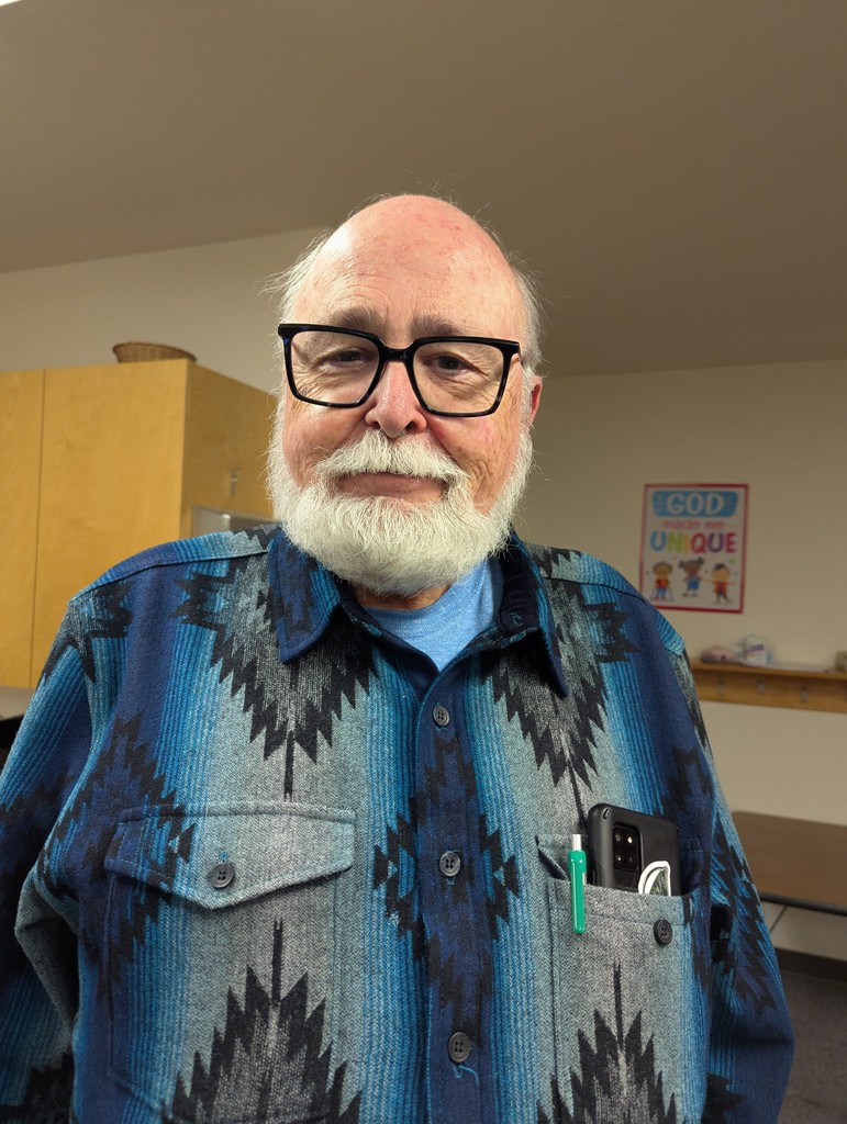 woman in gray coat singing on stage
