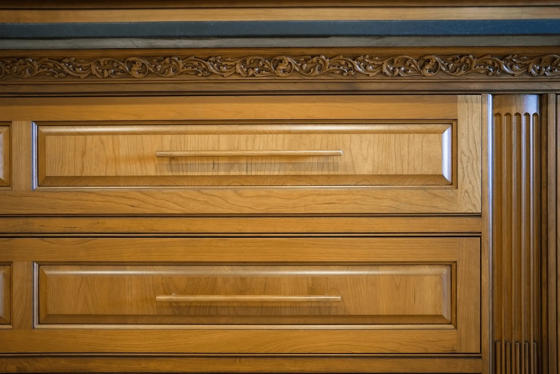 Close-up view of the entertainment room's cabinet drawers, demonstrating the fine craftsmanship and functional design in the San Juan Capistrano remodel. Photo by Todd Huge.