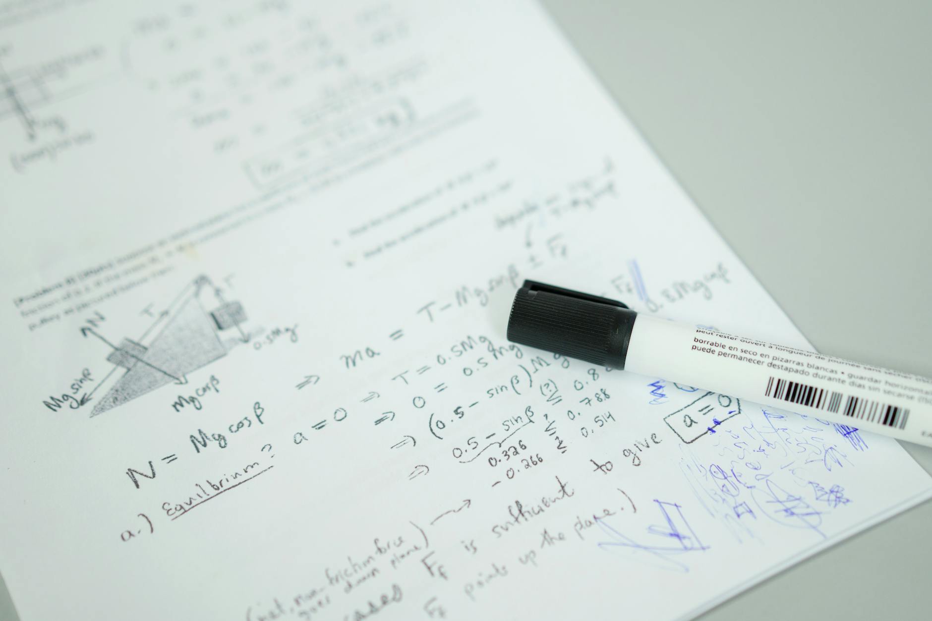 Close-up of a student completing a printed diagnostic assessment test with a pencil on a wooden desk.