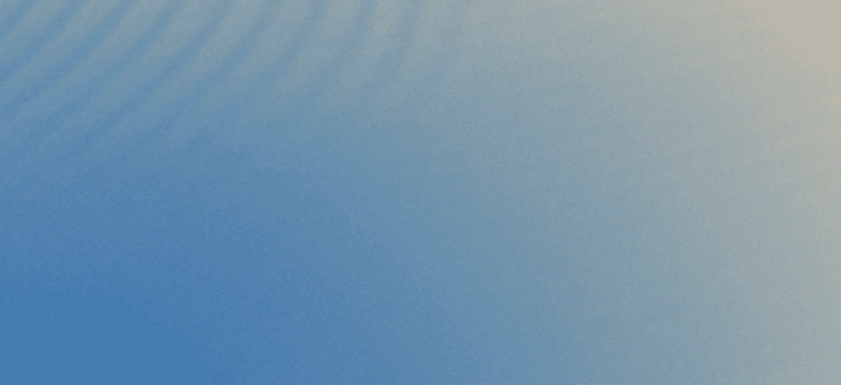 A gradient of blue fading to a lighter shade, with soft, subtle ripple patterns across the surface.