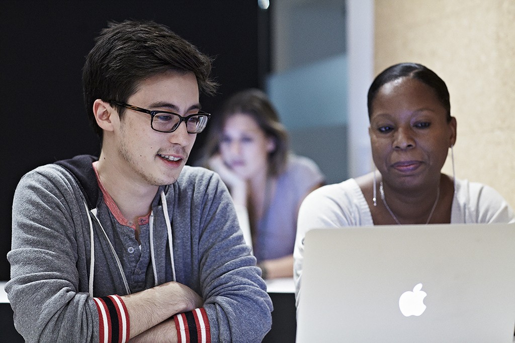 A review session mid-crit, one practitioner presenting a principle set to the group.