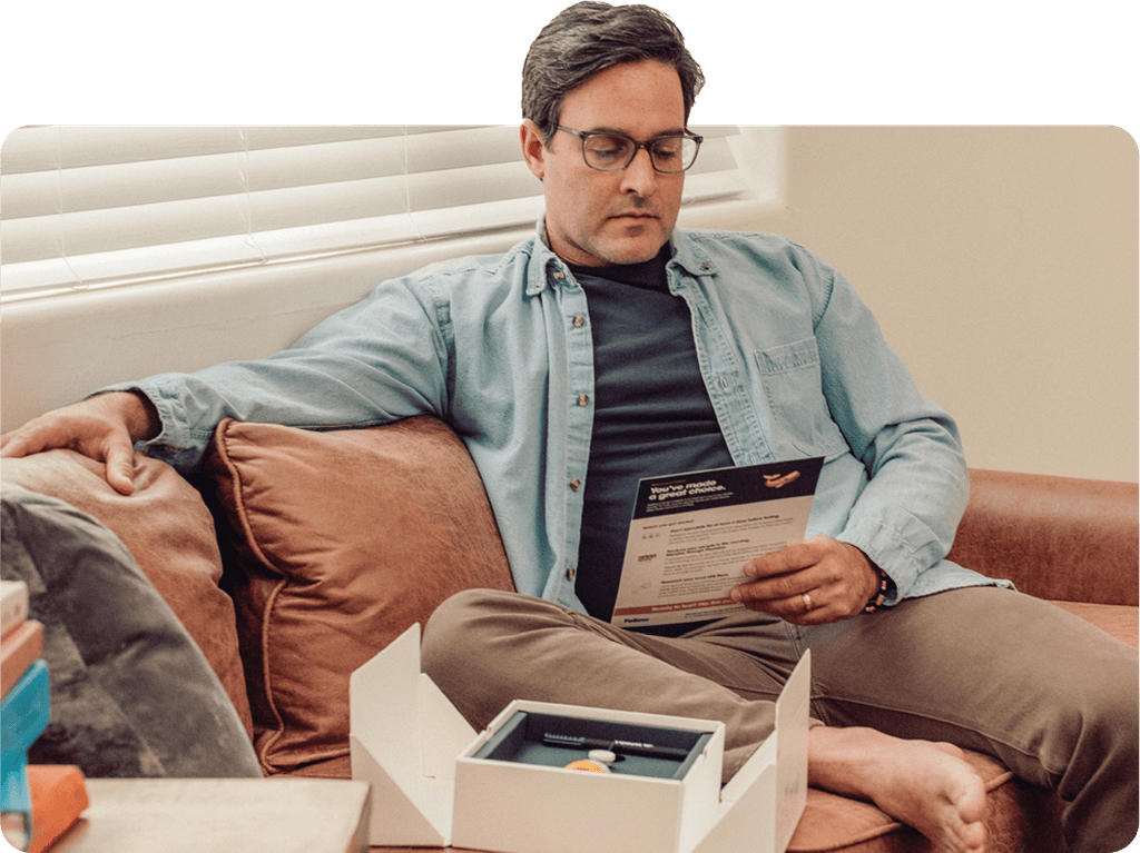 A man looks at the testing instructions for the Fellow Semen Analysis kit