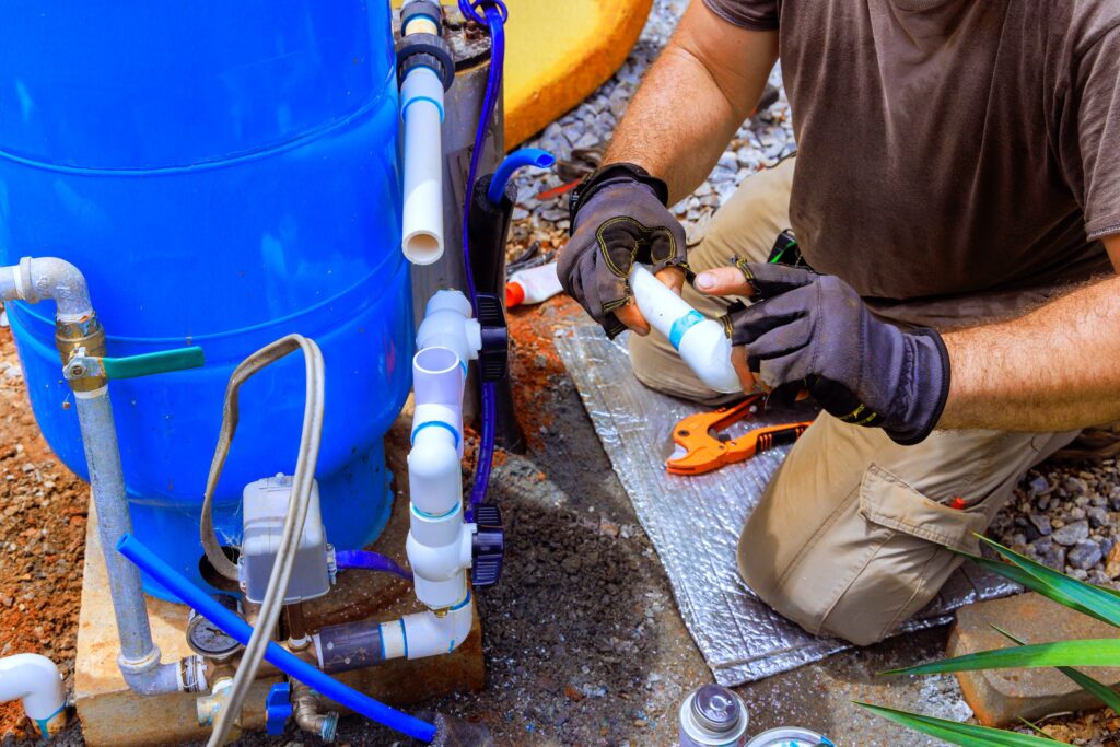 Plumber is assembling connection service between well water system in house