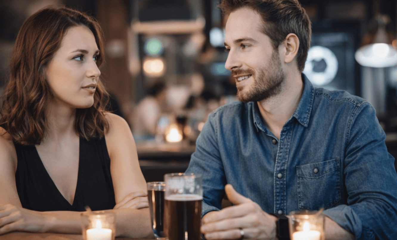 ein mann und eine frau sitzen in einer bar und reden miteinander