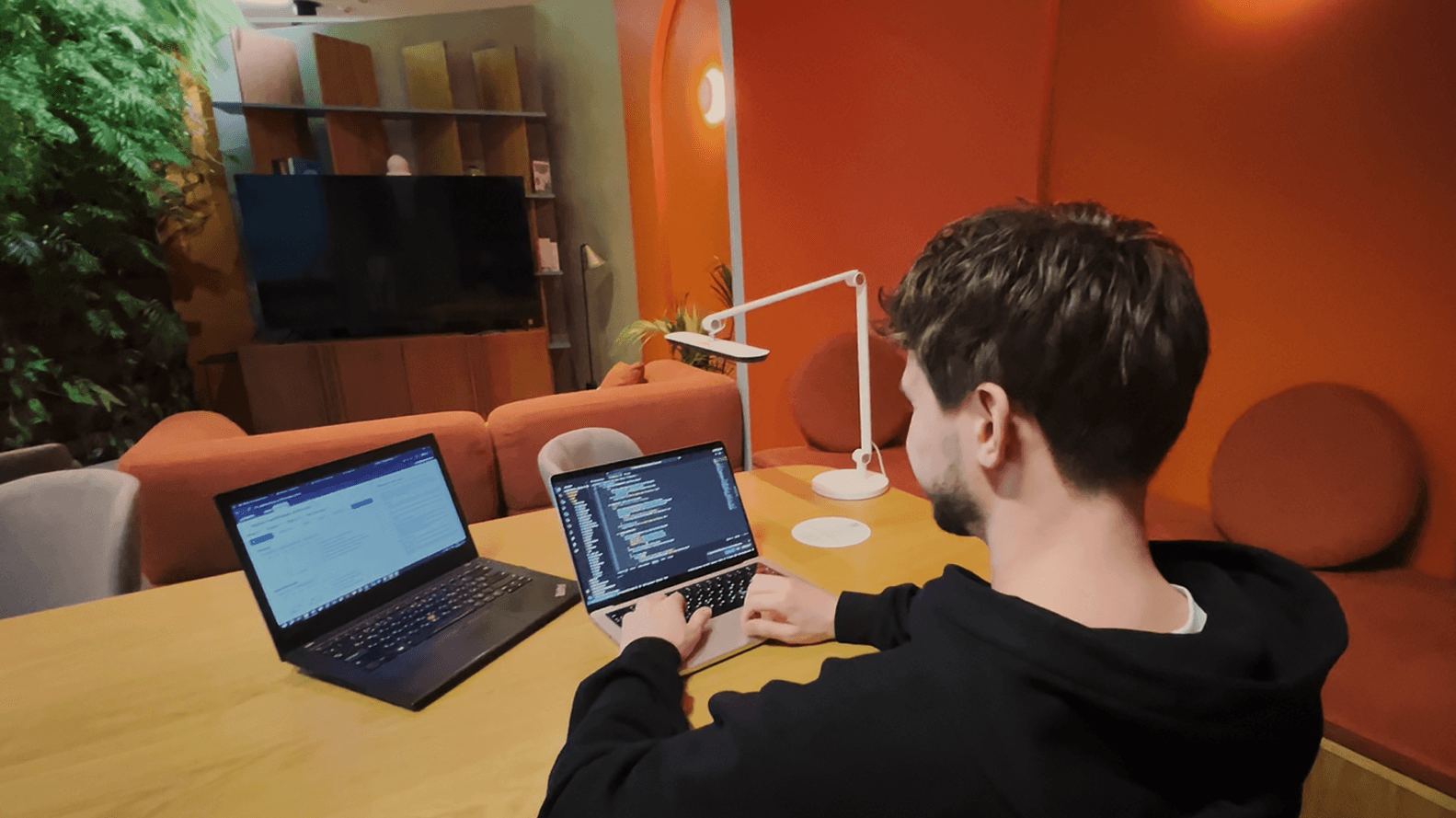 Close-up of hands holding a petri dish with visible samples, in a lab setting with soft golden lighting and scientific tools in the background.