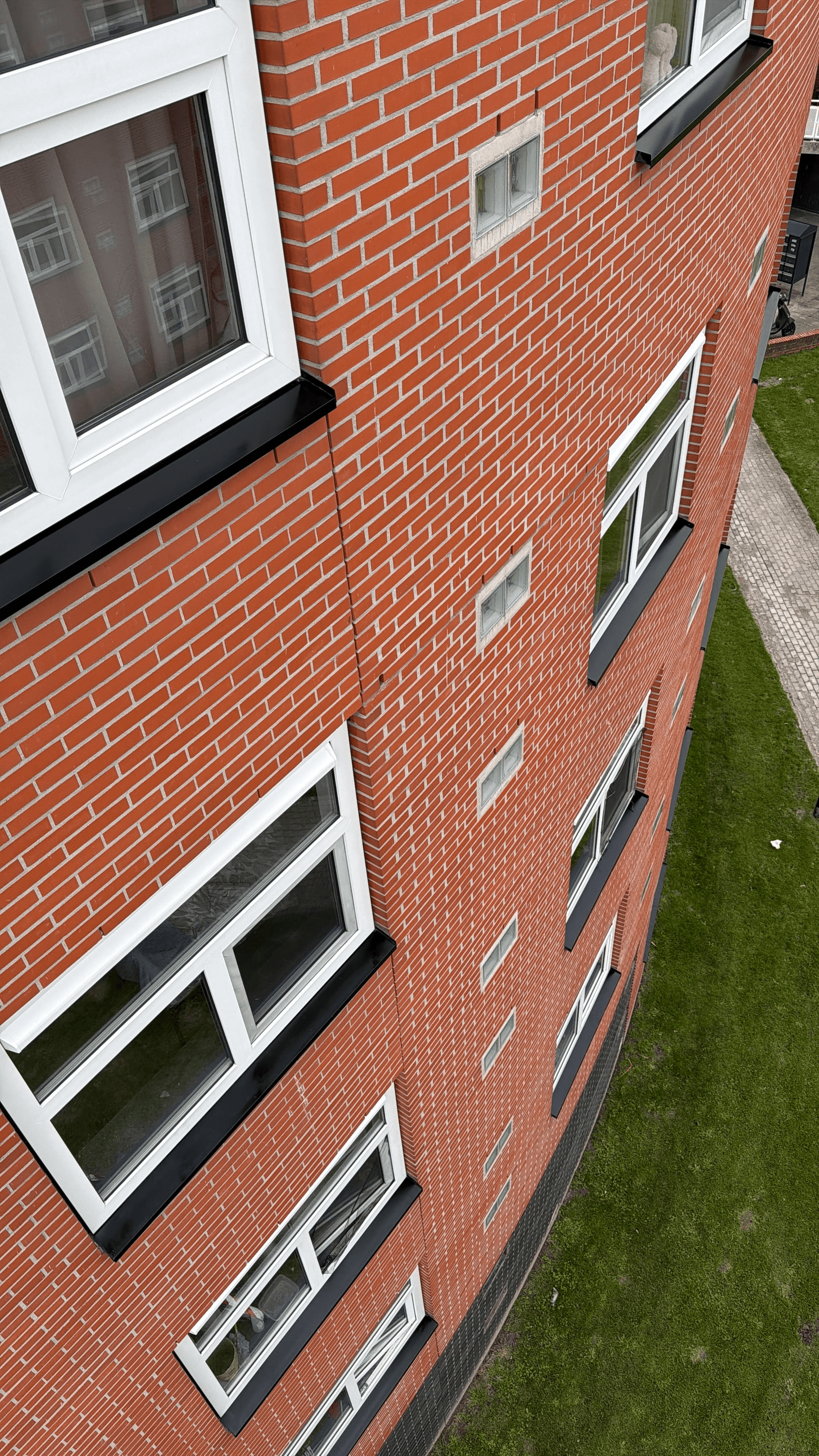 A diverse team collaborates around a table, analyzing documents and charts in a professional setting with a light green background.