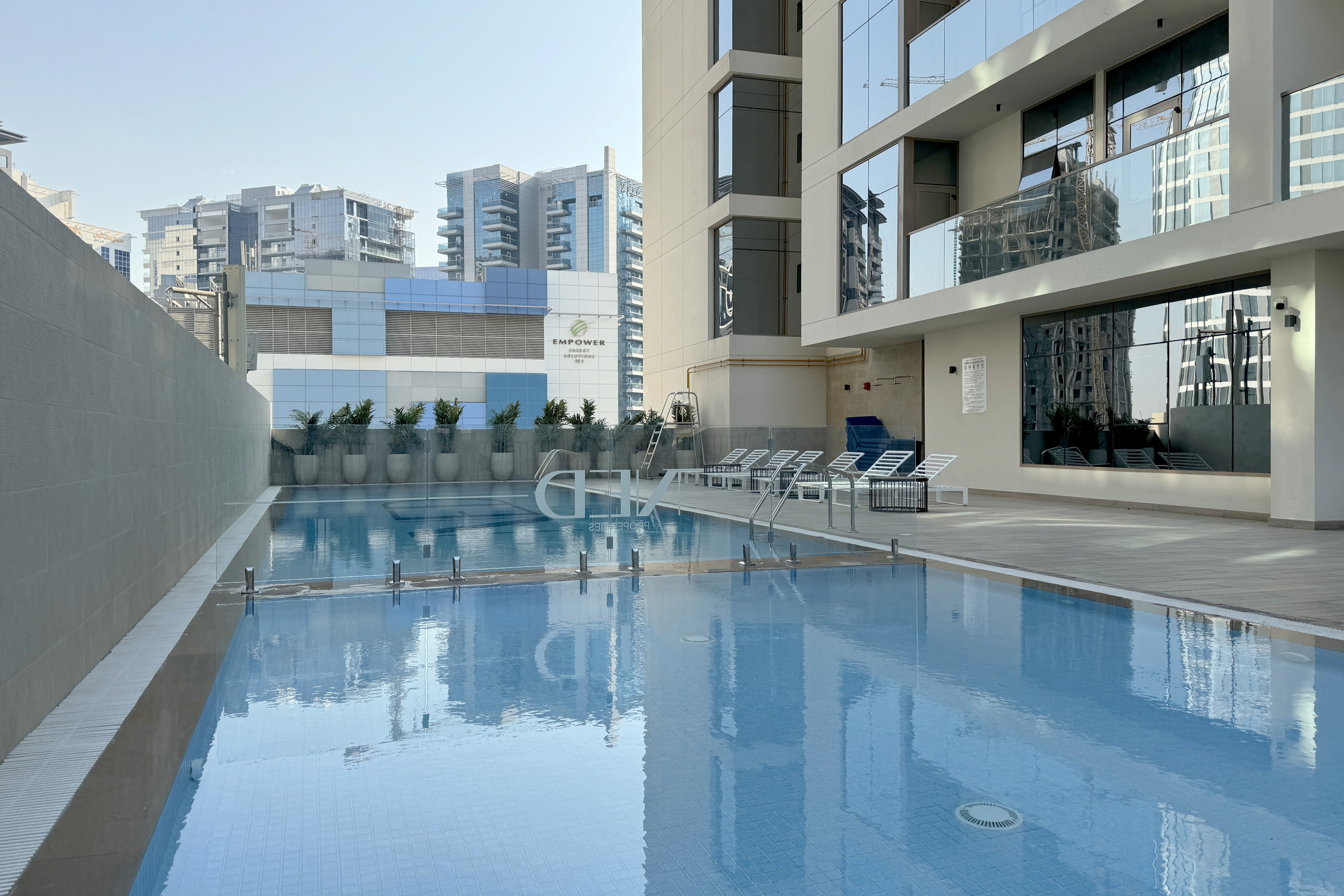 Canal Bay by NED infinity pool overlooking the waterfront — exclusive luxury amenities in Business Bay Dubai. Buy real estate with crypto on Tylt.