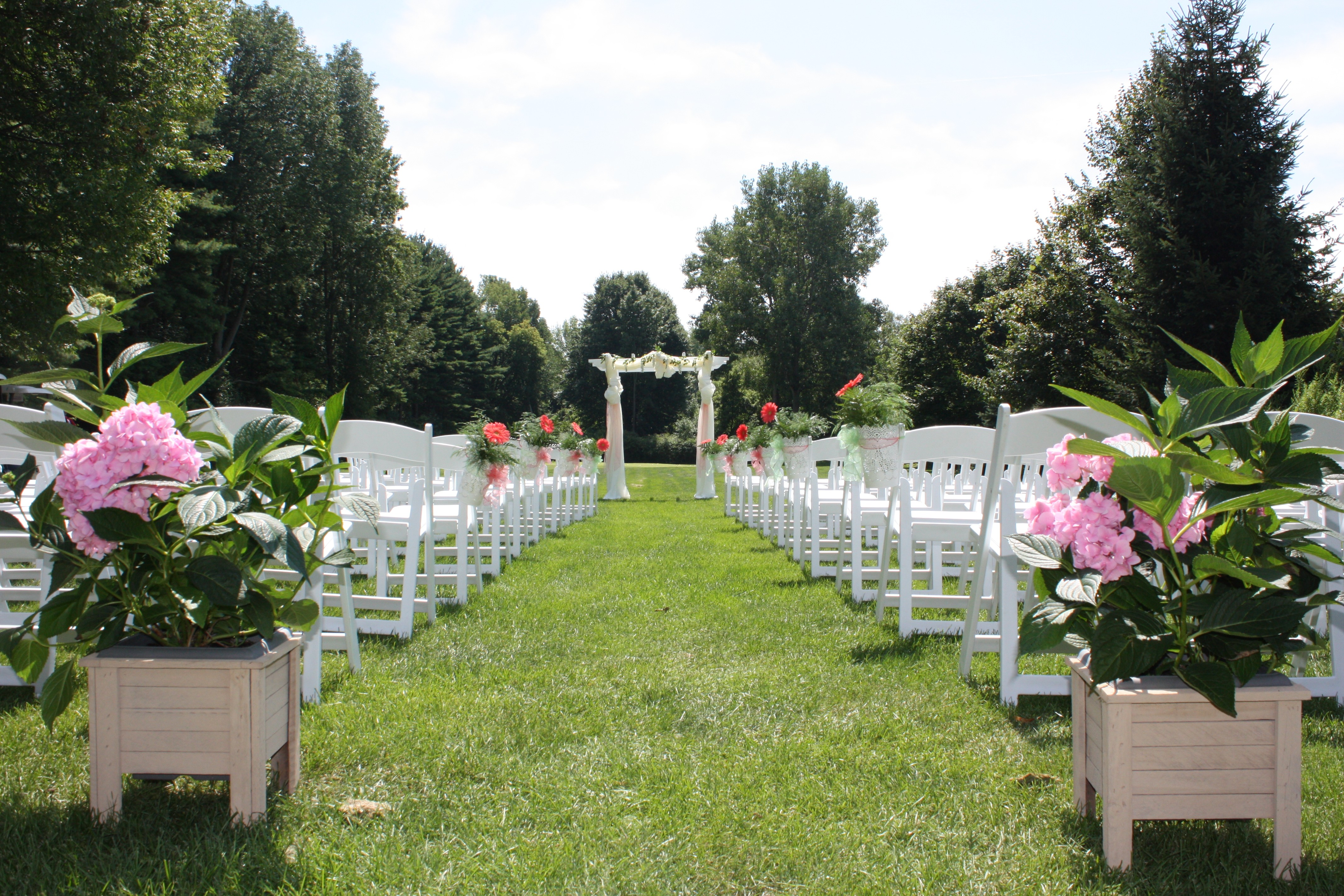 a man swinging a golf club on top of a green field