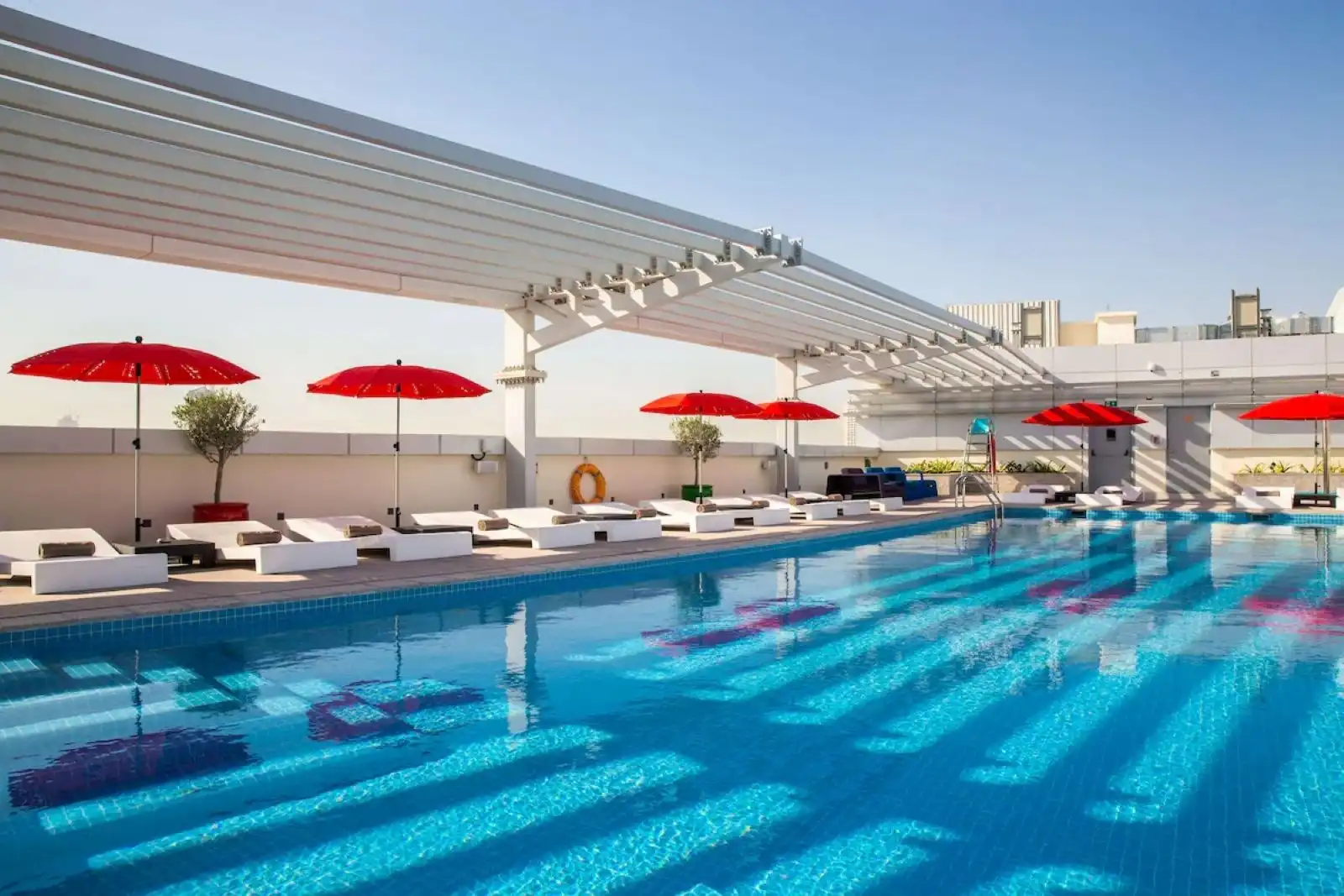 The outdoor pool at Park Inn by Radisson Dubai Motor City, a pet-friendly hotel with a motor-themed design