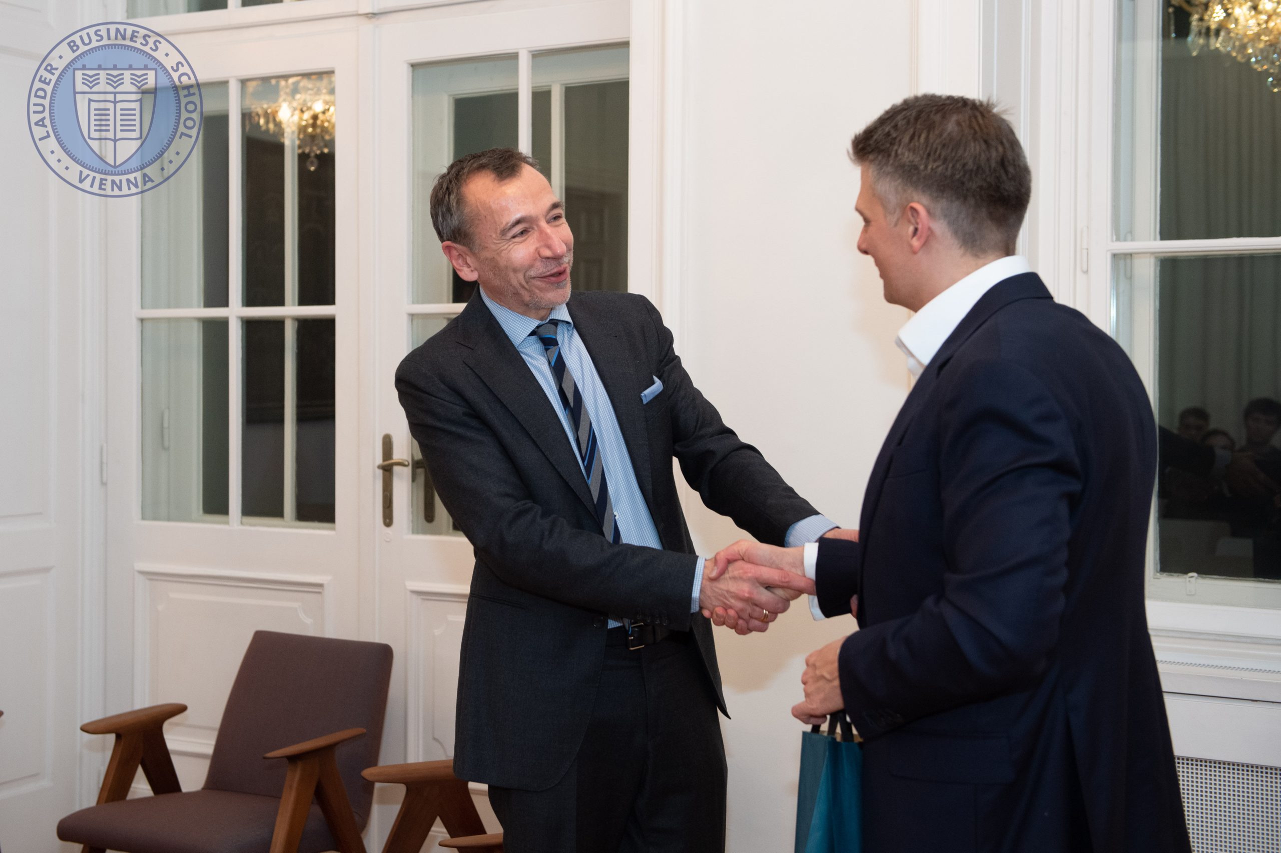Dr. Lóránd Balázs, Managing Director of AUMOVIO Autonomous Mobility Hungary shaking hands with Alexander Zirkler,  the Executive Director of LBS
