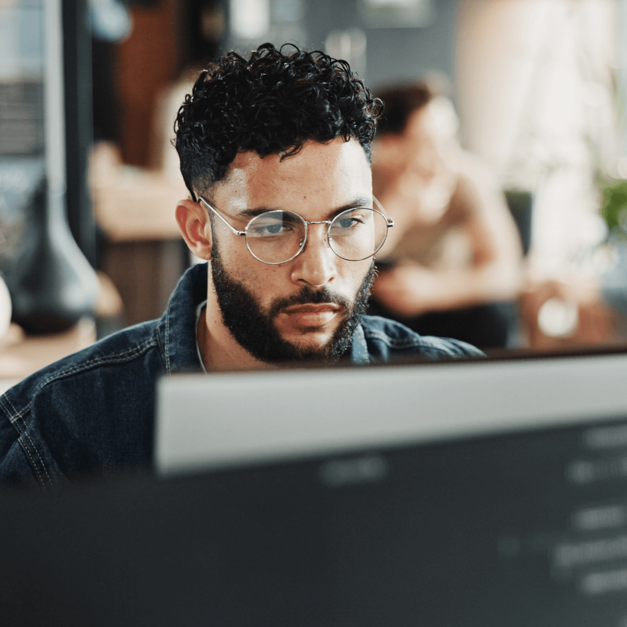 Focused data analyst working at his desk