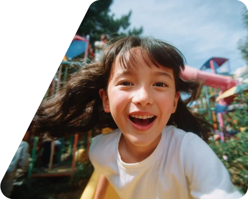 A joyful child smiles broadly, surrounded by iridescent bubbles in a sunlit garden, conveying a sense of happiness and playfulness.