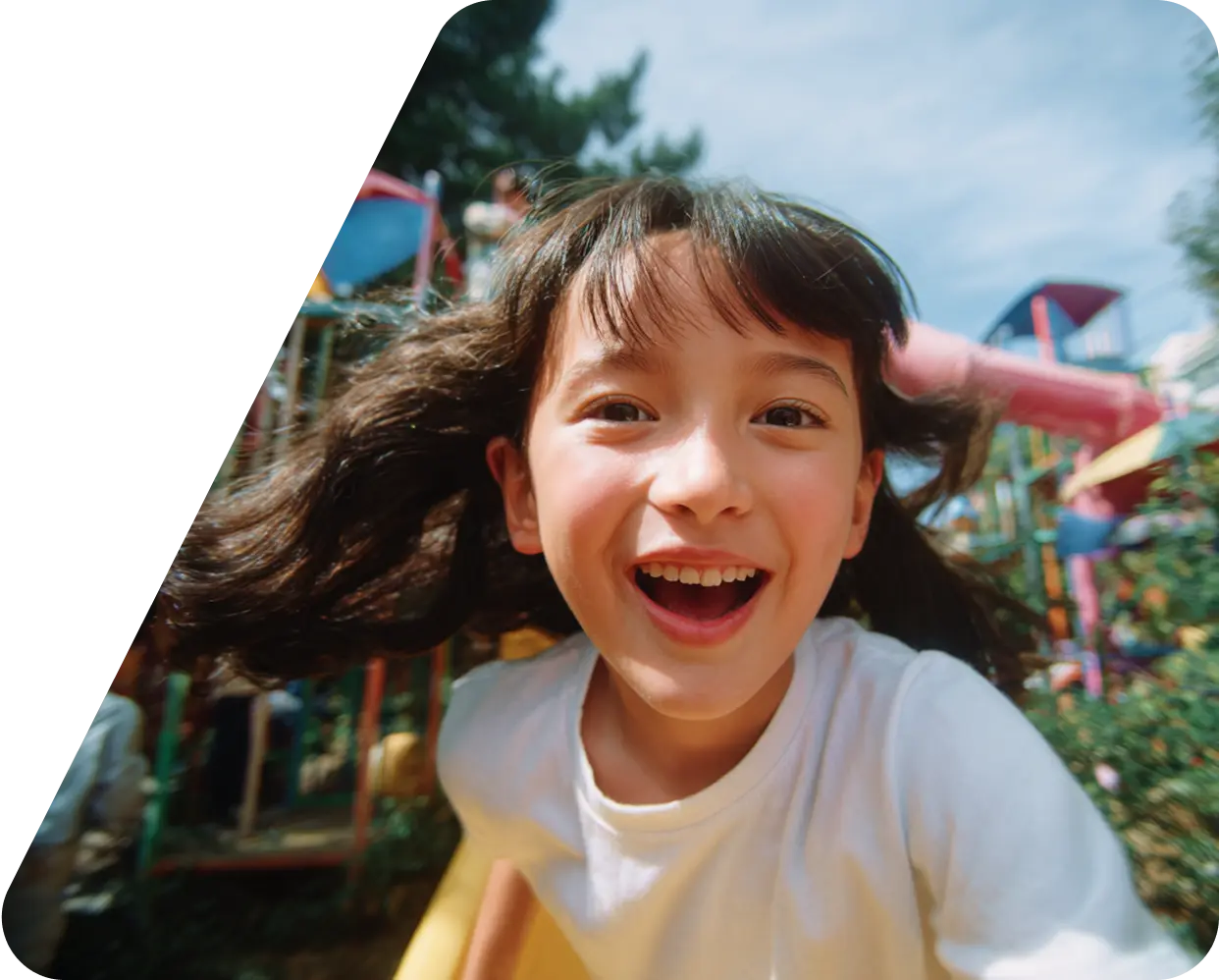 A joyful child smiles broadly, surrounded by iridescent bubbles in a sunlit garden, conveying a sense of happiness and playfulness.