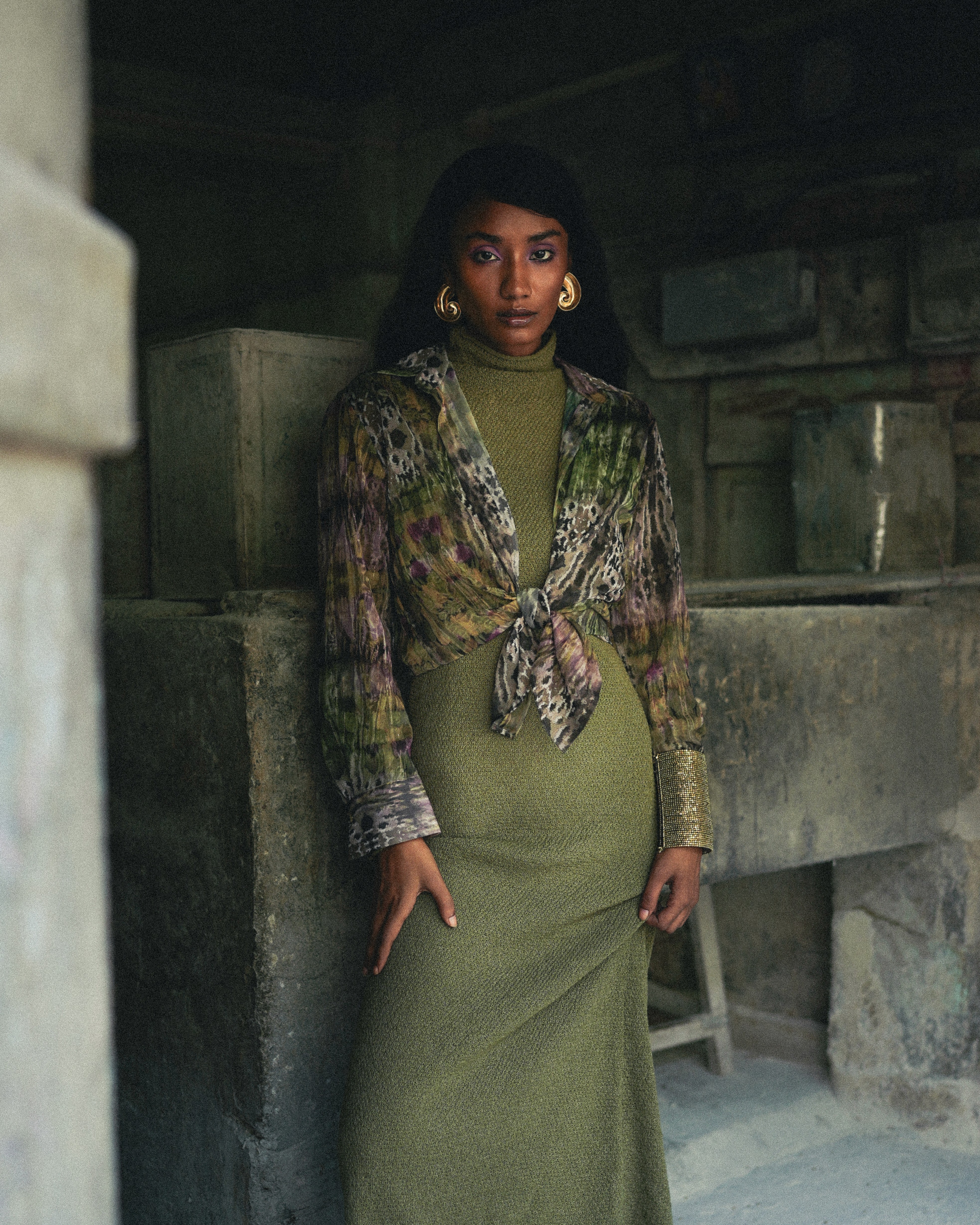 An astronaut posing in white elegance suit next to a frame