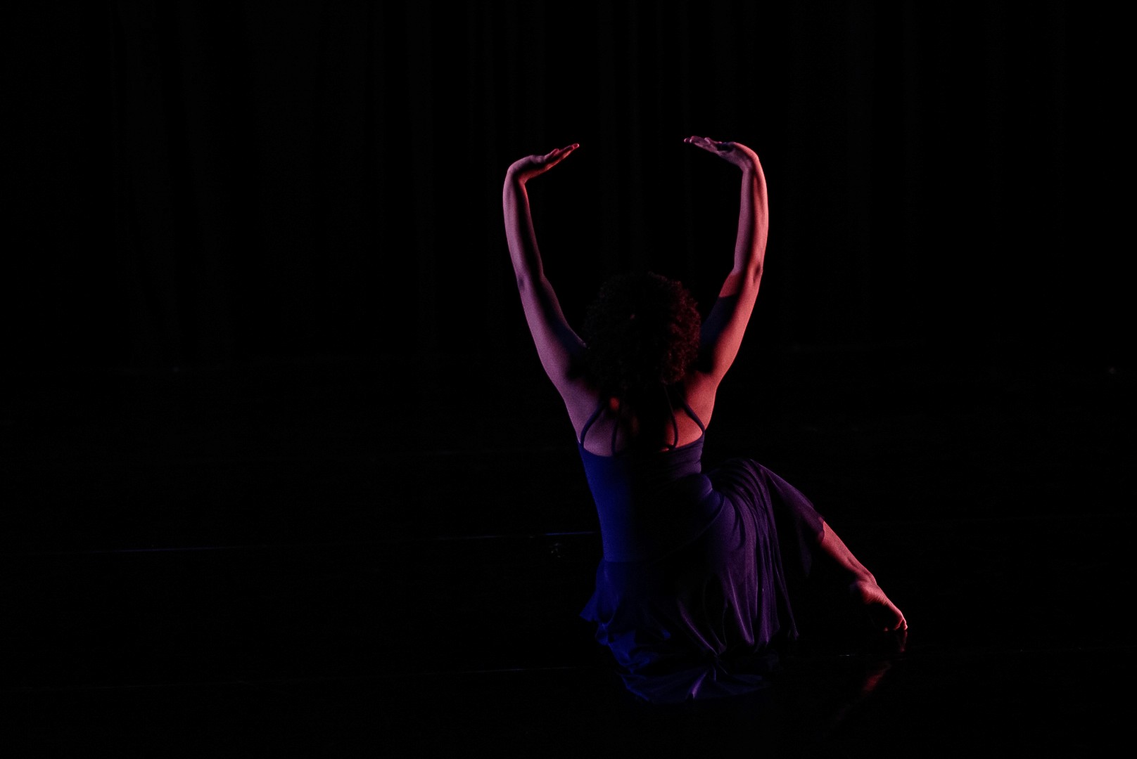 person sitting on grass and using phone