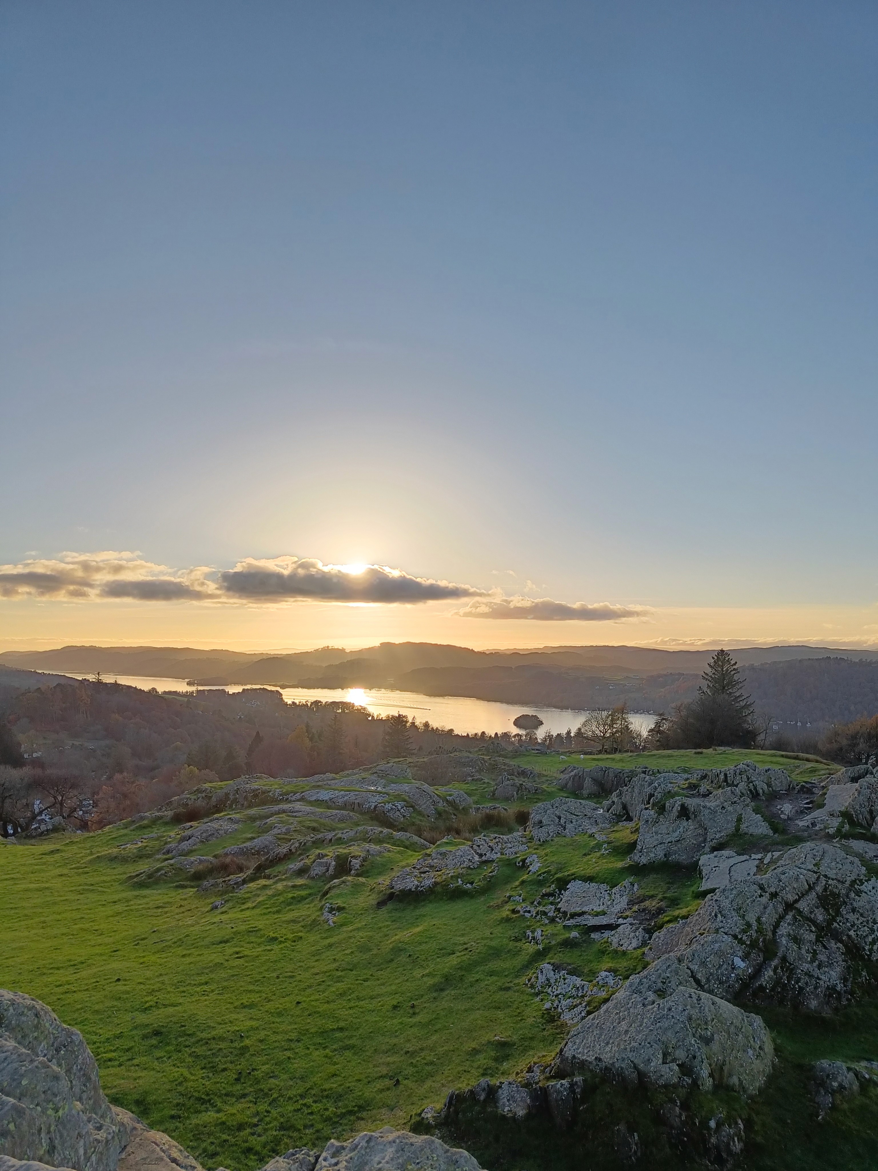 Sunset over rocky landscape and the sea.